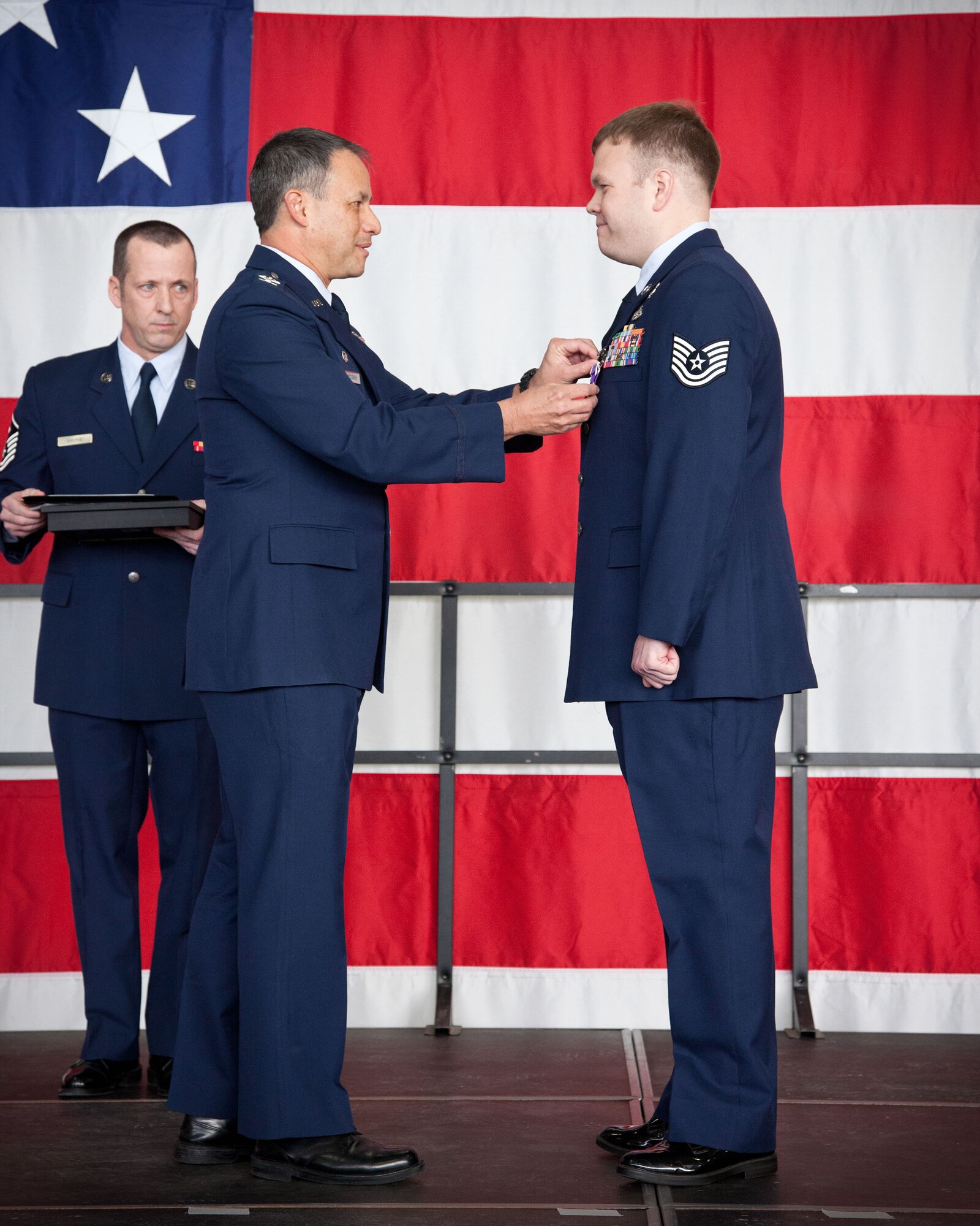 Col. Todd McCubbin, 934th Airlift Wing commander, awards Tech. Sgt. Justin Voorhees, 934th Civil Engineering Squadron, the Purple Heart during the January Wing Commander's Call at the Minneapolis-St. Paul Air Reserve Station, Minn.  (U.S. Air Force photo by Shannon McKay/Released)