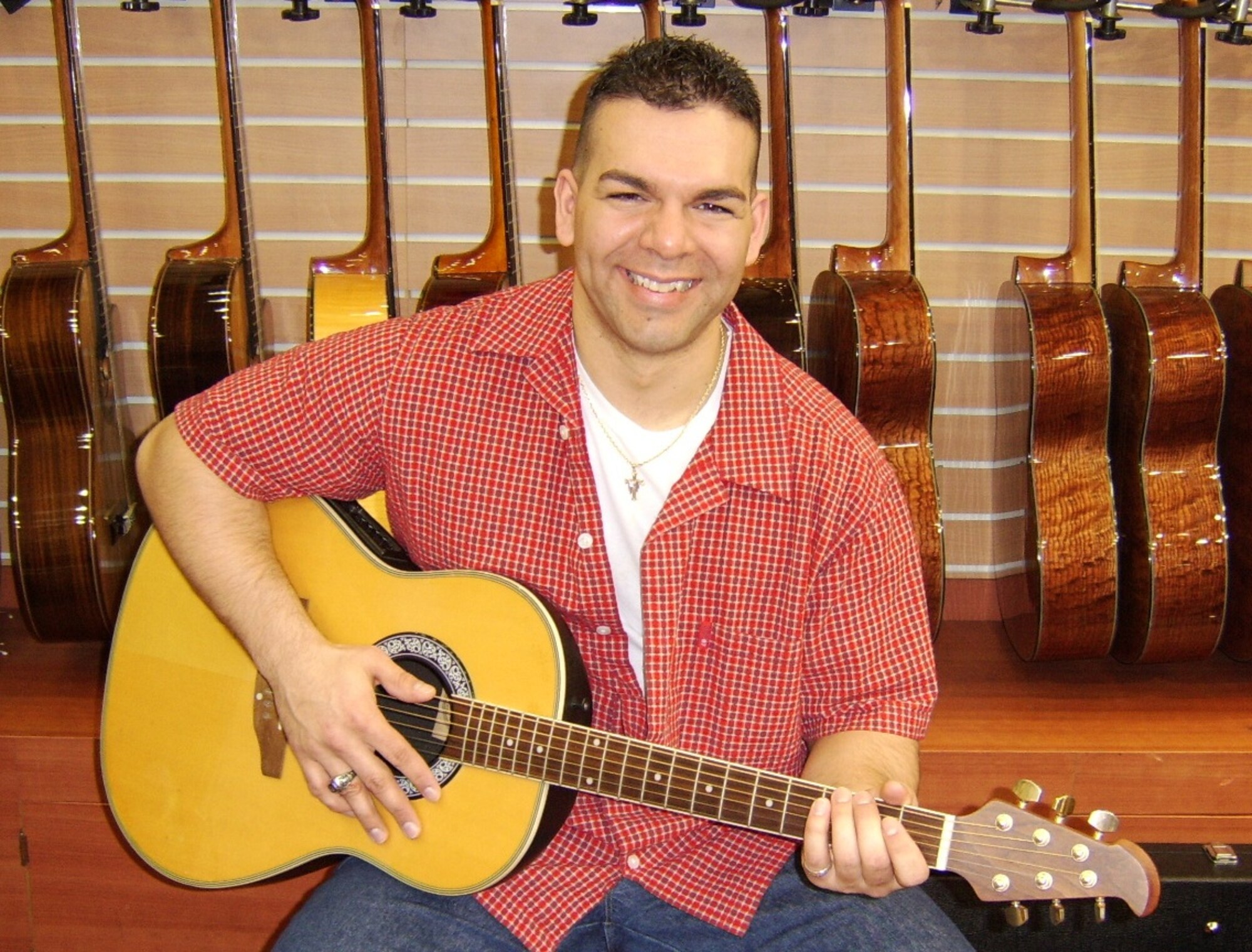 Staff Sgt. Brian Pop, 325th Maintenance Squadron armament maintenance team chief, poses for a photo with a guitar. Pop's primary duties are repairing and maintaining F-22 weapons equipment and armament suspension equipment. (Courtesy Photo)