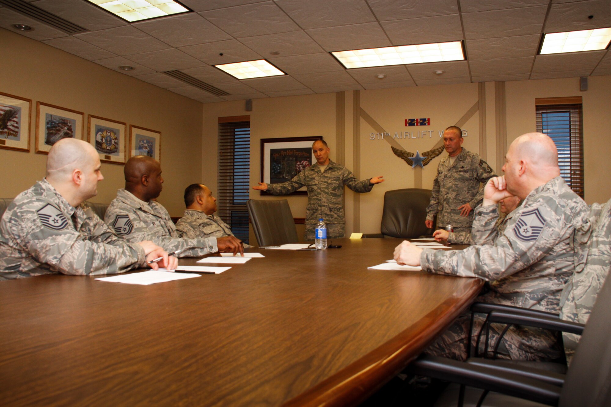 Command Chief Master Sgt. Brian L. Zator explains the selection process for the Quarterly and Yearly award winners to five senior noncommissioned officers, Jan. 12, 2014, at the Pittsburgh International Air Reserve Station.  Each command at the 911th Airlift Wing nominates one senior NCO to represent their organization on the selection board. The senior NCO’s meet quarterly and vote on award winners based on the packages submitted by the nominee’s supervisors. (U.S. Air Force photo by Senior Airman Justyne Obeldobel)
