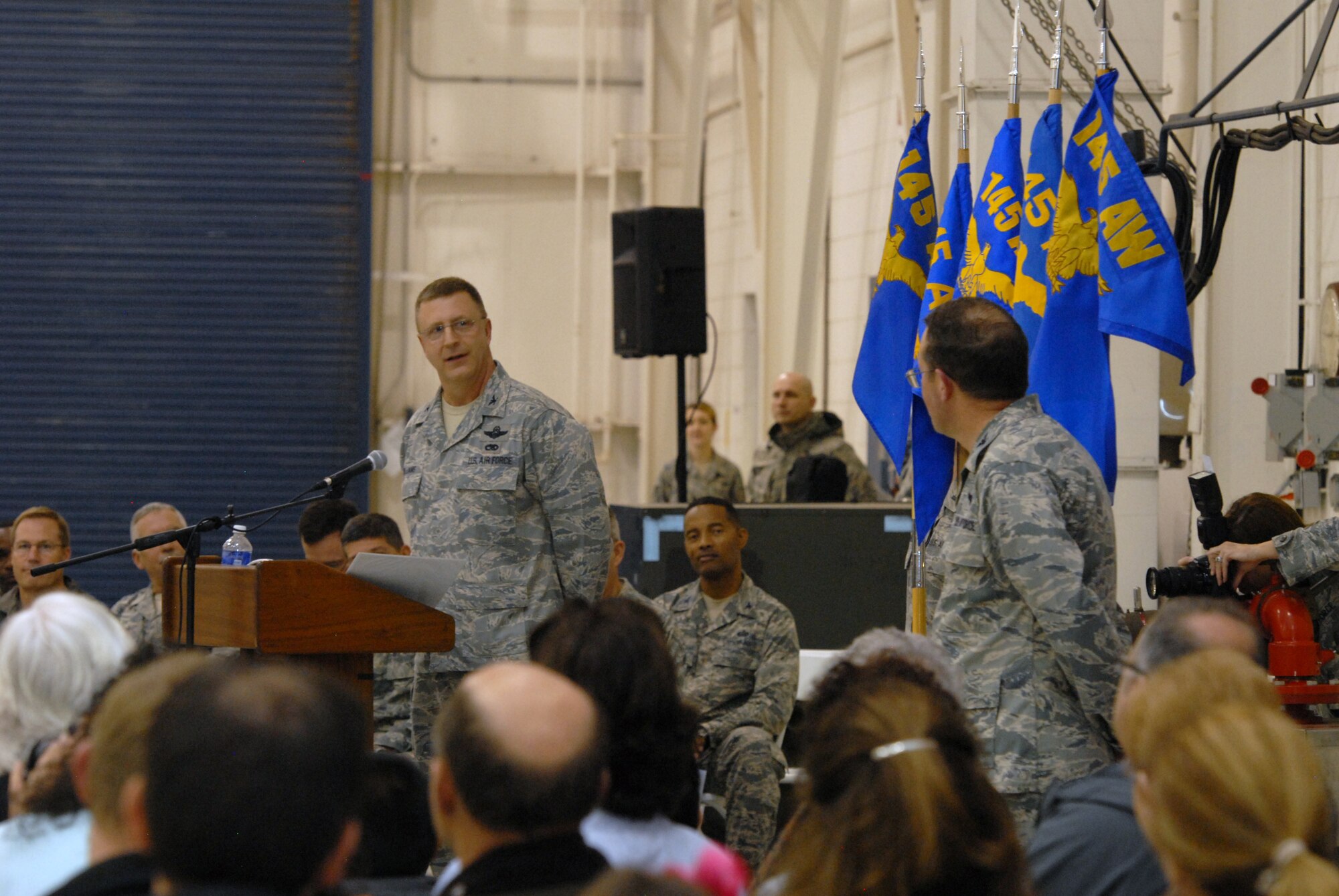 U.S. Air Force Col. Roger E. Williams, commander of the 145th Airlift Wing, gives accolades to Vice-Wing Commander, Col Quincy N. Huneycutt, during a Change of Command ceremony. Huneycutt relinquished his command of the 145th Mission Support Group. The CoC ceremony was at the North Carolina Air National Guard base, Charlotte-Douglas Intl. airport, Jan. 11, 2014. (U.S. National Guard photo by Senior Airman Laura Montgomery/Released)