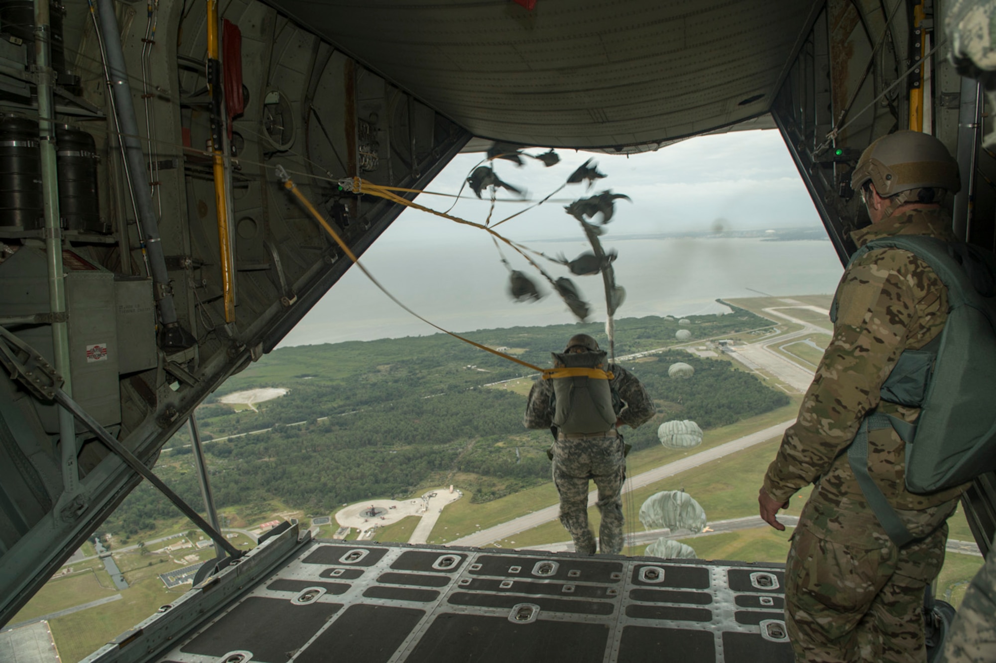 Paratroopers from the U.S. Army, Navy, Maries, and Air Force perform a static line jump from a C-130H2 aircraft belonging to the 136th Airlift Wing, Texas Air National Guard during a joint airborne air transportability training at McDill AFB, Fla., Nov. 15, 2013. The paratroopers jumped from 1,000 feet above ground level. . (Air National Guard photo by Senior Master Sgt. Elizabeth Gilbert/released)