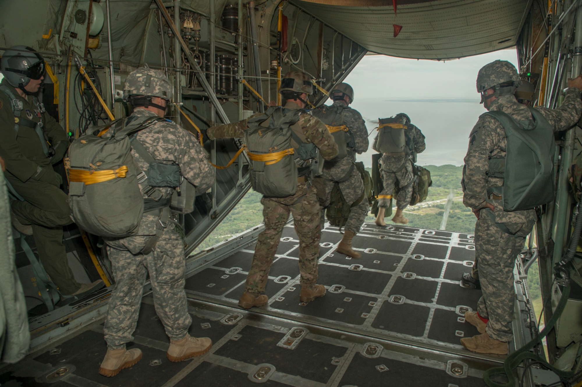 Paratroopers from the U.S. Army, Navy, Maries, and Air Force do a static line jump from a C-130H2 aircraft belonging to the 136th Airlift Wing, Texas Air National Guard during a joint airborne air transportability training at McDill AFB, Fla., Nov. 15, 2013. The paratroopers jumped from 1,000 feet above ground level. . (Air National Guard photo by Senior Master Sgt. Elizabeth Gilbert/released)