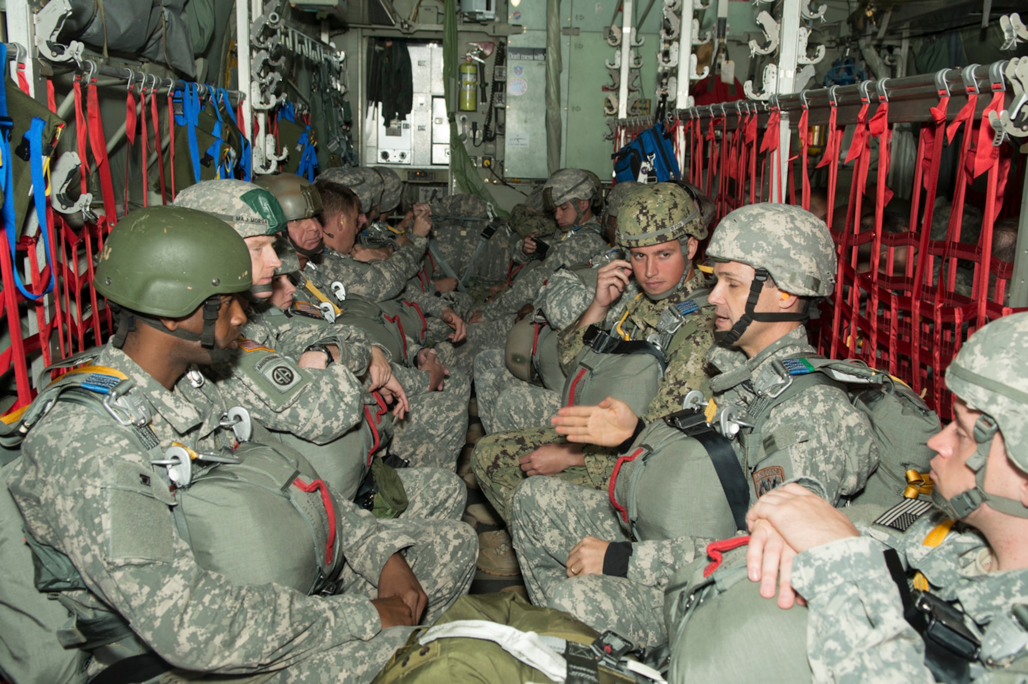 Paratroopers from the U.S. Army, Navy, Marines and Air Force prepare to do a static line jump from a C-130H2 aircraft belonging to the 136th Airlift Wing, Texas Air National Guard during a joint airborne air transportability training at McDill AFB, Fla., Nov. 15, 2013. The paratroopers jumped from 1,000 feet above ground level. (Air National Guard photo by Senior Master Sgt. Elizabeth Gilbert/released)