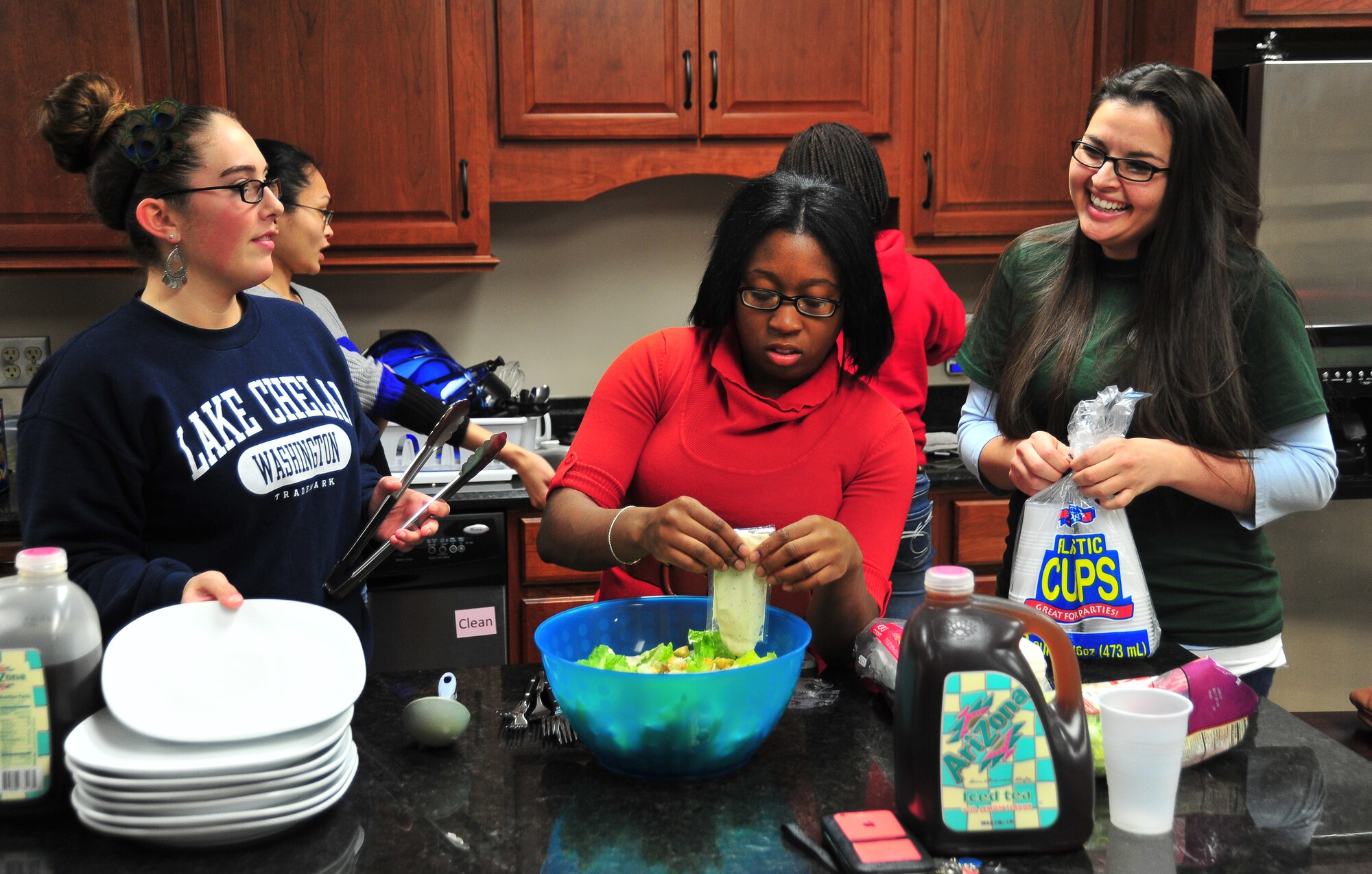 Members of the Female Dorm Resident Association cook dinner together Jan. 23 at the Airmen and Family Readiness Center. (U.S. Air Force photo by Airman 1st Class Sergio Gamboa)