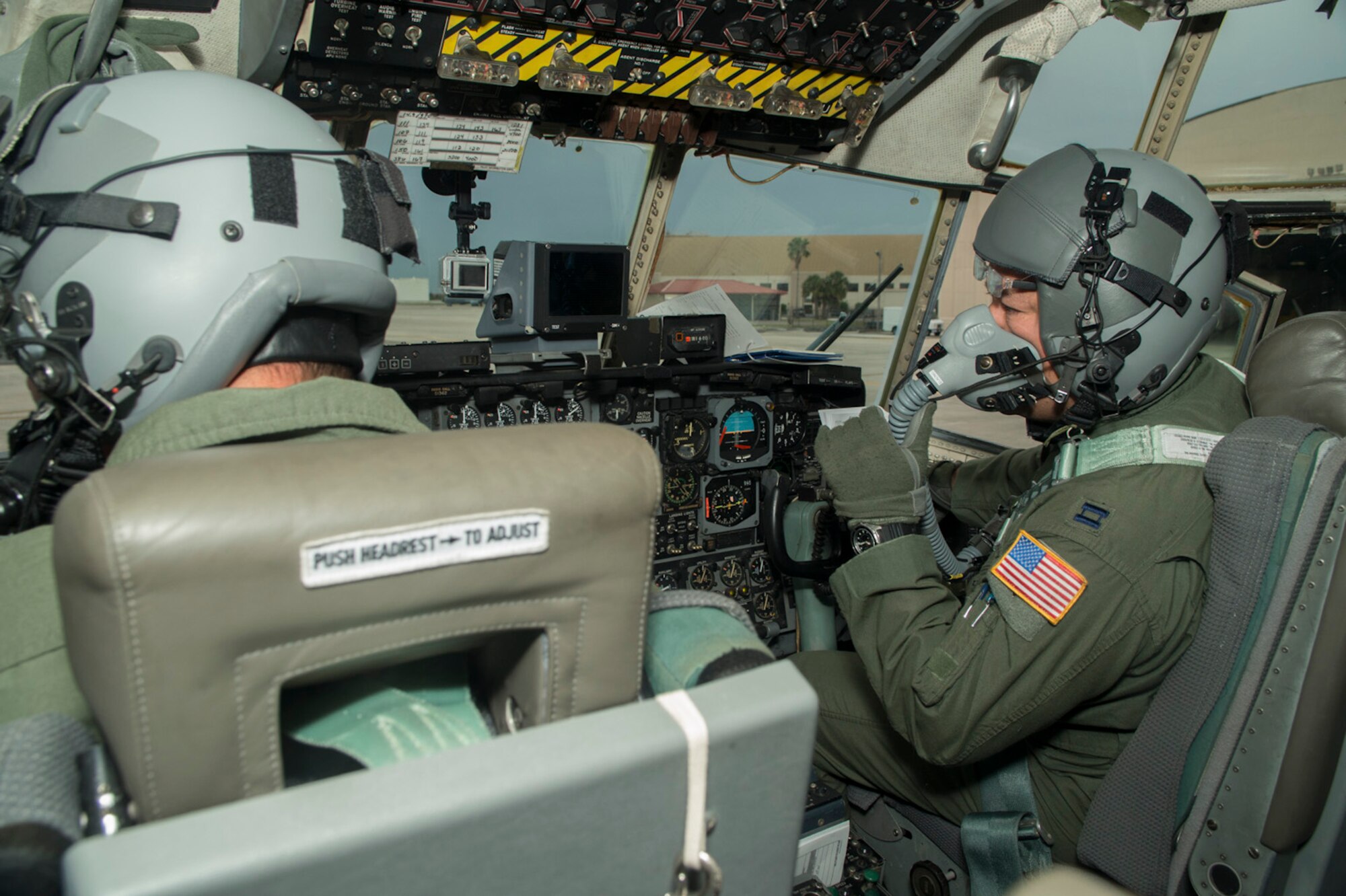 U.S. Air Force Capt. Patrick Lacicero, co-pilot of the C-130 H2 aircraft from the 181st Airlift Squadron, Texas Air National Guard prepares his oxygen mask for the high altitude air drop at 25,000 feet above ground level at McDill Air Force Base, Fla., Nov. 15, 2013. The mission is a joint airborne air transportability training (JAAT) with the U.S. Army, Navy, Marines and Air Force paratroopers. (Air National Guard photo by Senior Master Sgt. Elizabeth Gilbert/released)