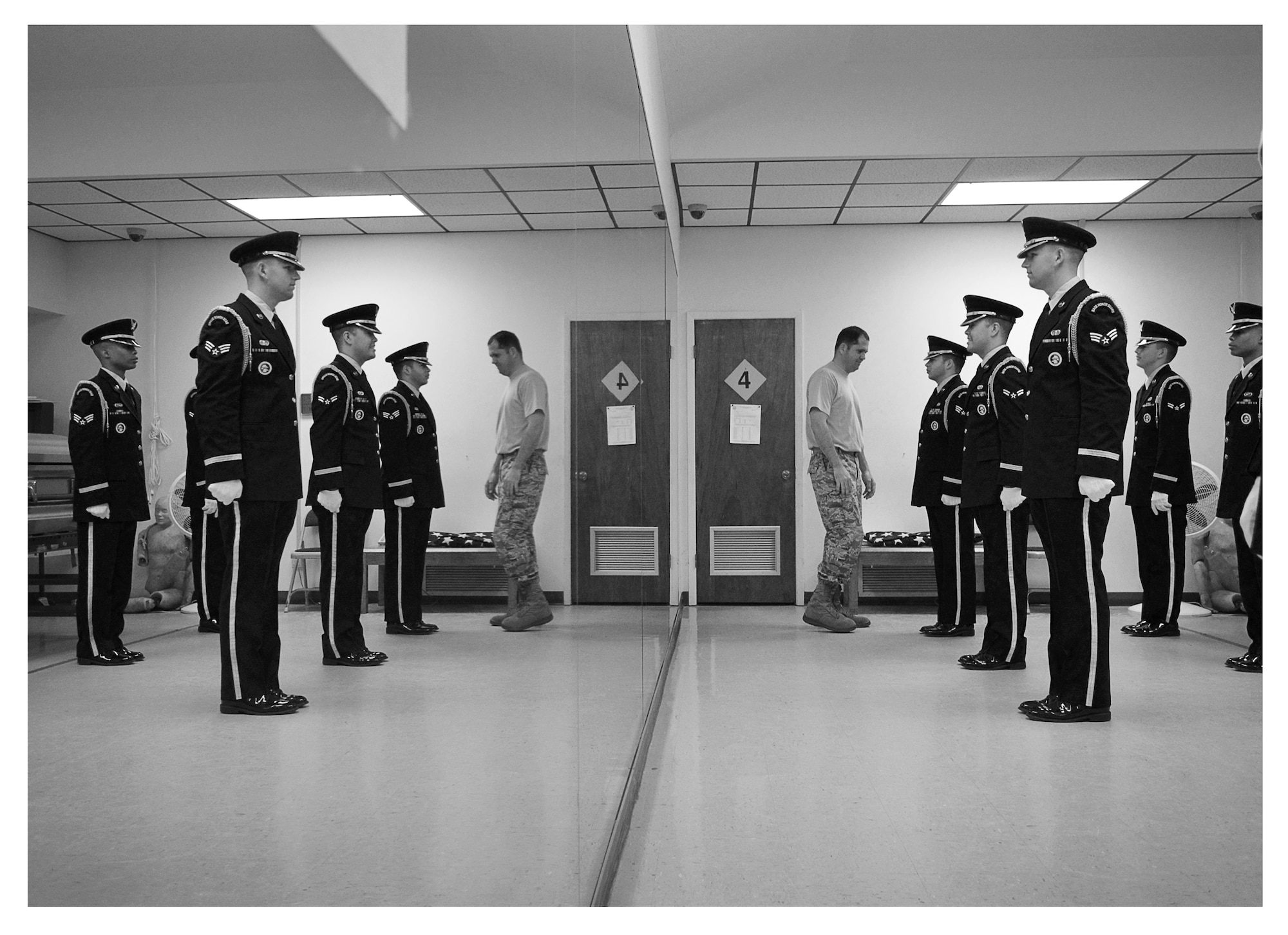 Master Sgt. Larry Cerbantec, Tyndall Base Honor Guard superintendent, inspects the uniforms of a new rotation of honor guard members, Dec .16 at Tyndall. The base honor guard’s primary mission is to provide military funeral honors for active duty, retiree and veteran members, who served honorably in the United States Air Force and Army Air Corp. (U.S. Air Force photo illustration by Staff Sgt. Javier Cruz)