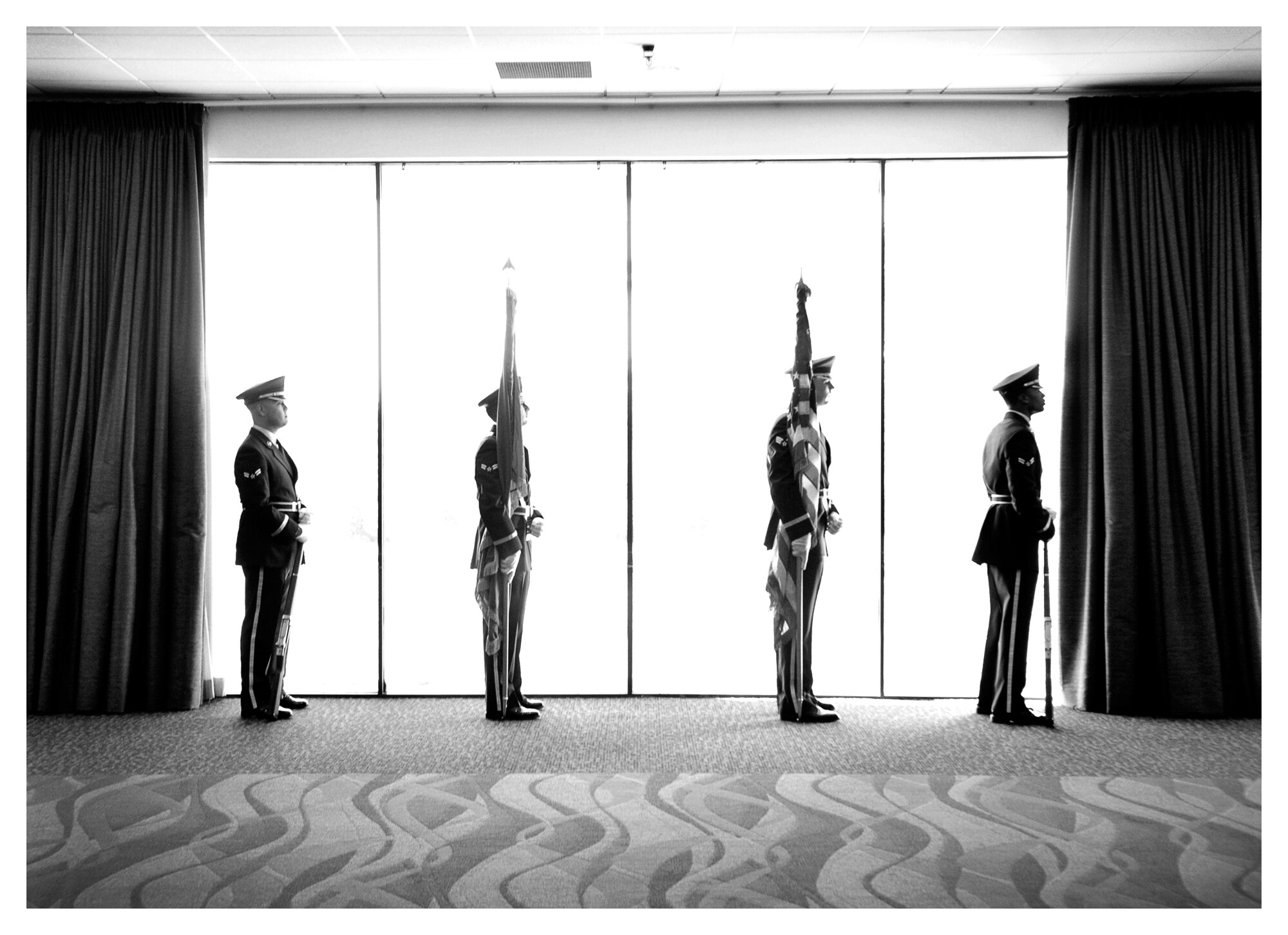 Members of the base honor guard wait to enter the Horizons ballroom for the presentation of the colors and the singing of the national anthem, Dec. 18 at Tyndall. The base honor guard’s primary mission is to provide military funeral honors for active duty, retiree and veteran members, who served honorably in the United States Air Force and Army Air Corp. (U.S. Air Force photo illustration by Staff Sgt. Javier Cruz)