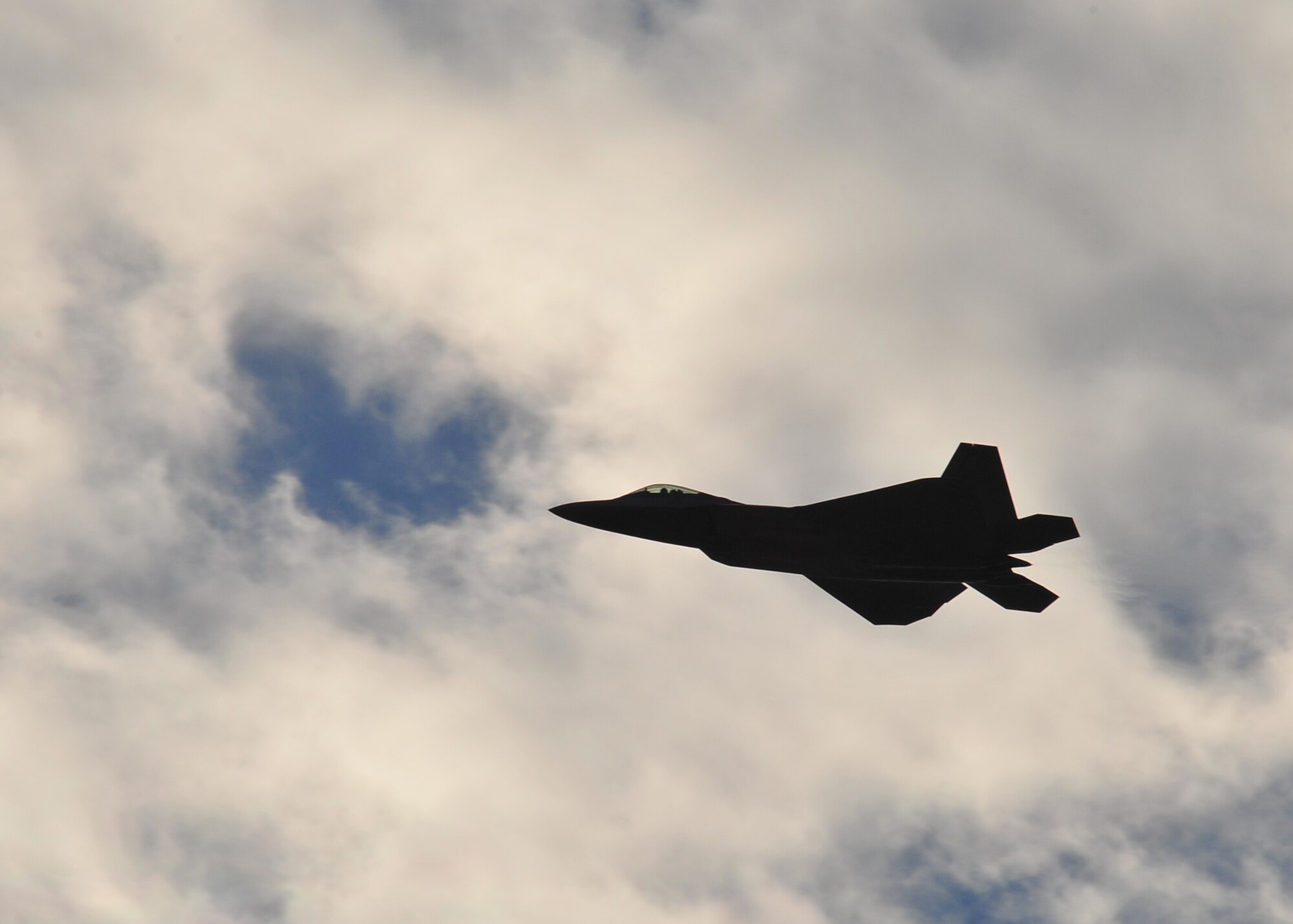 Capt. John Cummings, F-22 Raptor Demonstration pilot, practices his routine over Tyndall on Jan. 23. While Cummings will do most of his training at Langley, Air Force Instructions require him to make three off-station practice flights of the routine before performing at an air show. (Air Force Photo by Airman 1st Class Dustin Mullen)