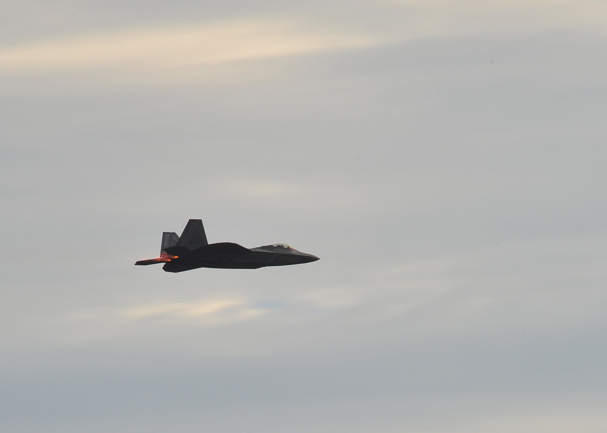 Capt. John Cummings, F-22 Raptor Demonstration pilot, practices his routine over Tyndall on Jan. 23. While Cummings will do most of his training at Langley, Air Force Instructions require him to make three off-station practice flights of the routine before performing at an air show. (Air Force Photo by Airman 1st Class Dustin Mullen)