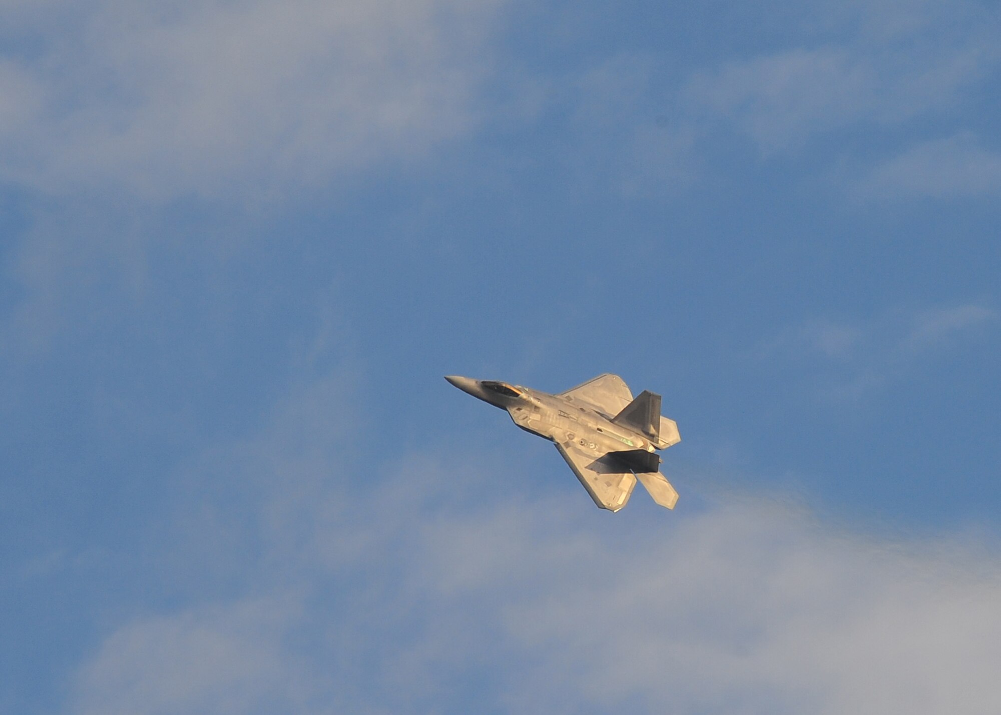 Capt. John Cummings, F-22 Raptor Demonstration pilot, practices his routine over Tyndall on Jan. 23. While Cummings will do most of his training at Langley, Air Force Instructions require him to make three off-station practice flights of the routine before performing at an air show. (Air Force Photo by Airman 1st Class Dustin Mullen)