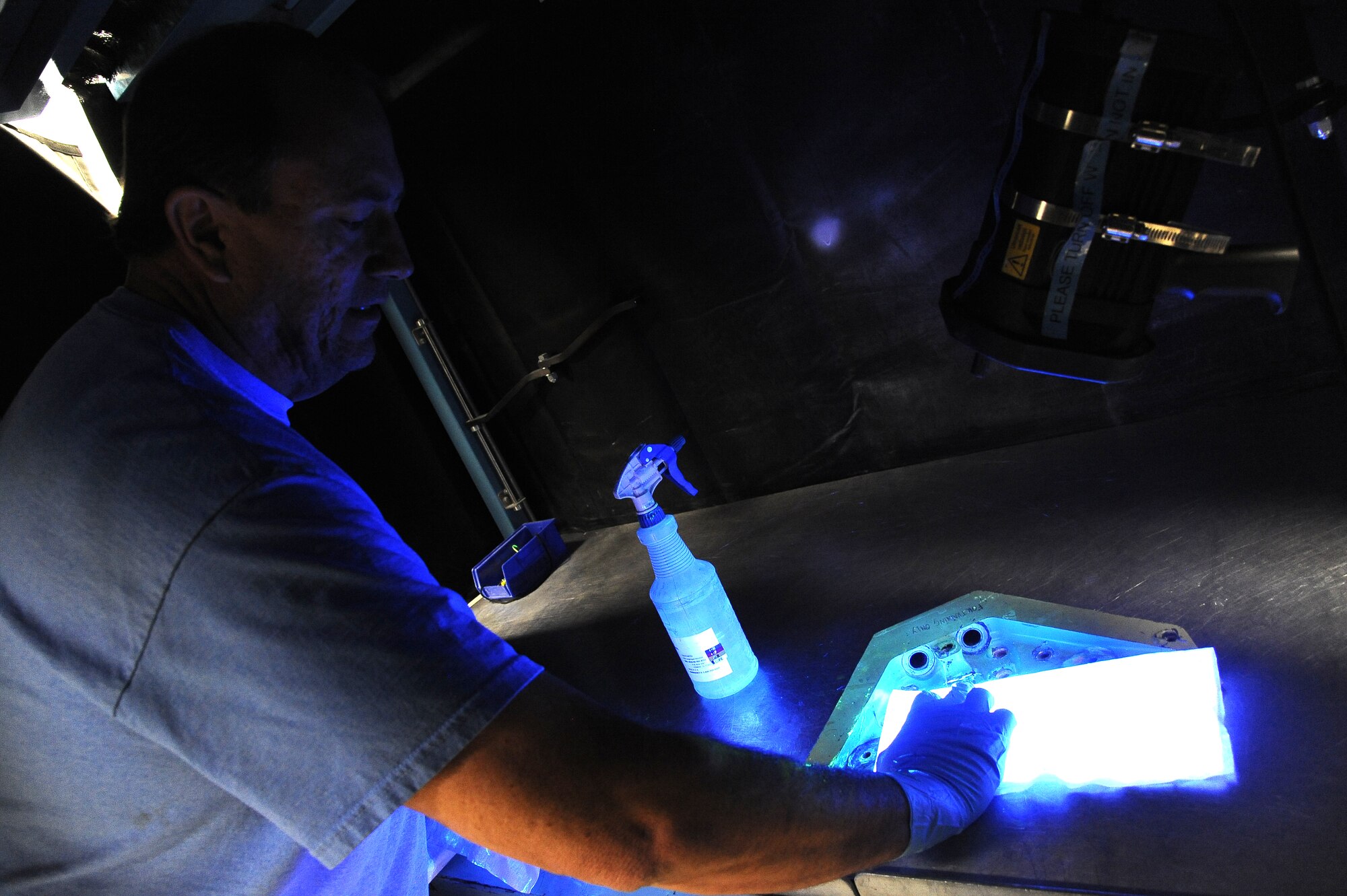 Doug Reeser, 56th EMS nondestructive inspection technician, inspects a wing attachment using the dye penetrant method used to detect cracks or damage to an aircraft’s components that may not be visible to the naked eye. (U.S. Air Force photo/Airman 1st Class Pedro Mota