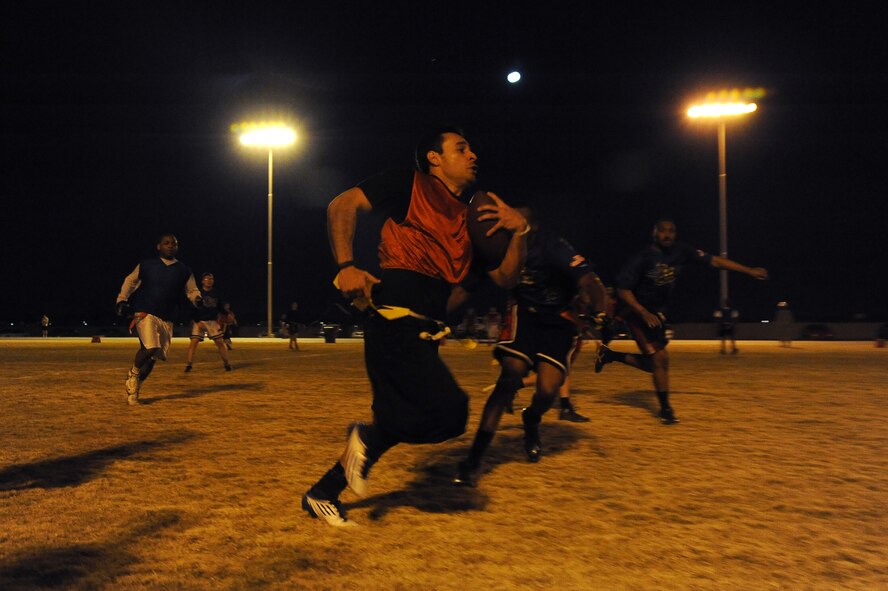 Petty Officer 2nd Class Oscar Alvarez , Navel Operation Support Center Guam military police, returns an interception against the 607th Air Control Squadron Jan. 14 at Luke Air Force Base. The Navy team defeated the 607th ACS by a score of 26-0. (U.S. Air Force photo/Airman 1st Class Pedro Mota