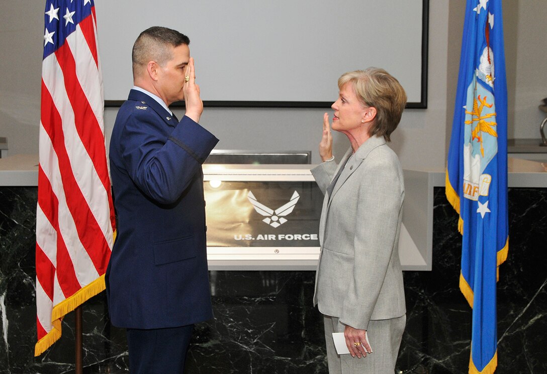 Amy Foster (right), the newly appointed AEDC Contracting director, is shown here being sworn in by AEDC Commander Col. Raymond Toth at her promotion ceremony. Foster will oversee contracts totaling approximately $300 million annually. (Photo by Jacqueline Cowan)