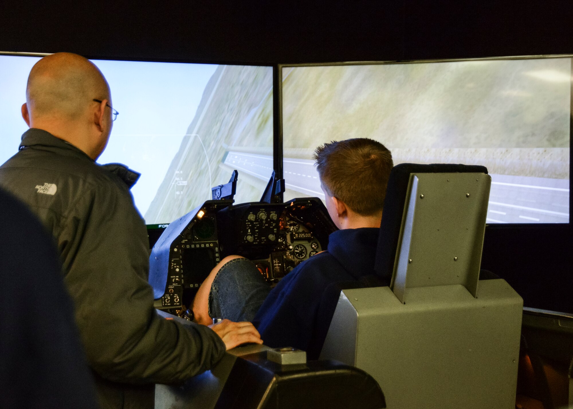 A student from a local high school experiences the F-16 Simulator at the 412th Electronic Warfare group Jan. 22. (U.S. Air Force photo by Rebecca Amber)
