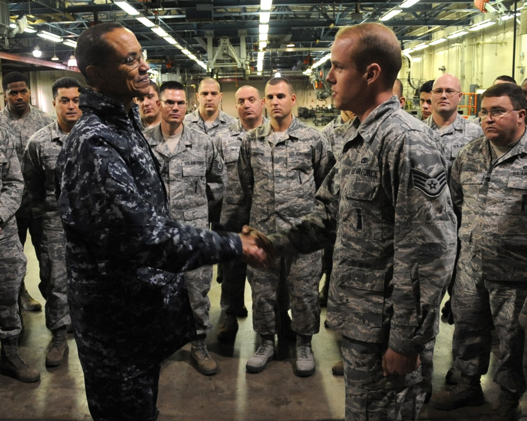 Adm. Cecil D. Haney, U.S. Strategic Command commander, presents a coin to Staff Sgt. Brian Dunn, 2nd Maintenance Group weapons load crew team chief, on Barksdale Air Force Base, La., Jan. 23, 2014. Dunn was chosen to receive the coin for being recognized as an outstanding performer during Exercise Prairie Vigilance. (U.S. Air Force photo/Staff Sgt. Sean Martin)

