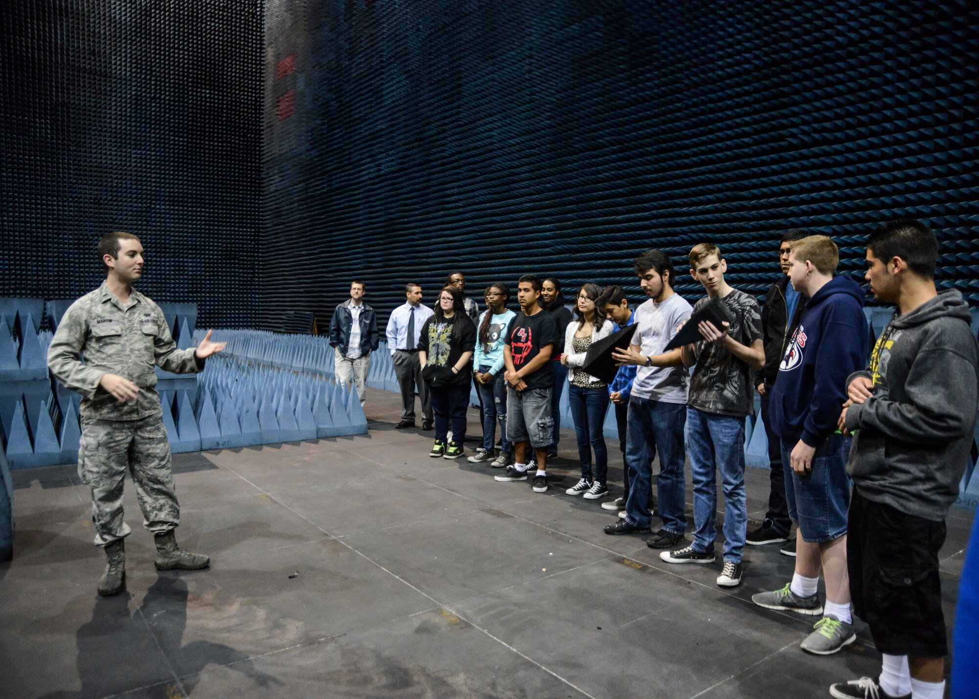 1st Lt. Seth Martin, a 412th Electronic Warfare Group engineer, shows the students from local high schools what radio absorbent material looks like in the Benefield Anechoic Facility. (U.S. Air Force photo by Rebecca Amber)