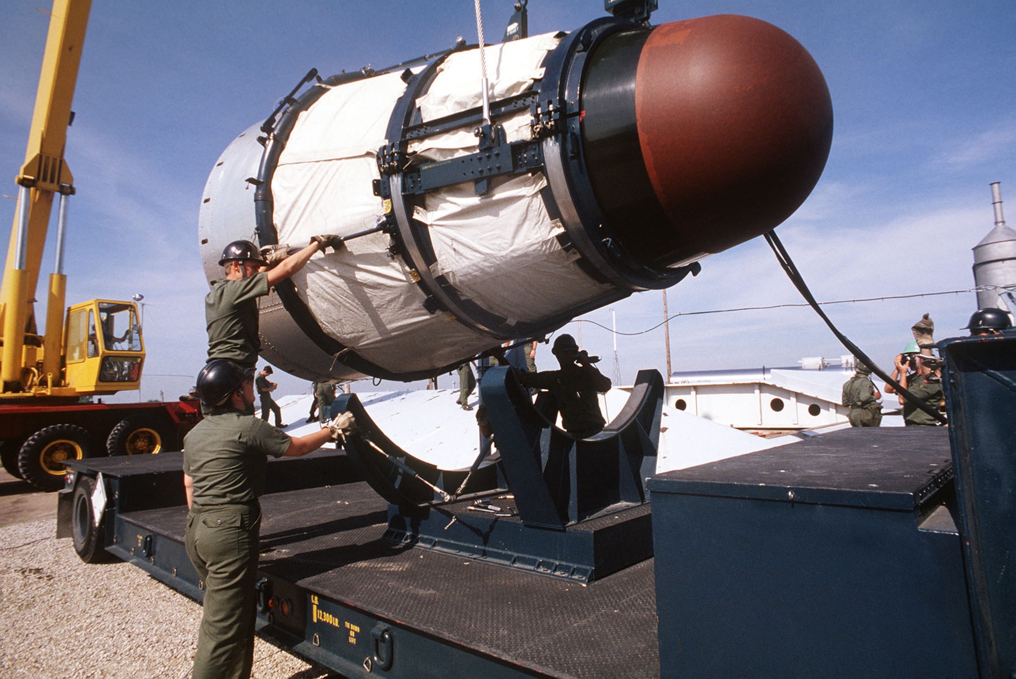 Maintenance personnel removing the Mk-6 re-entry vehicle from a Titan II missile. (U.S. Air Force photo)