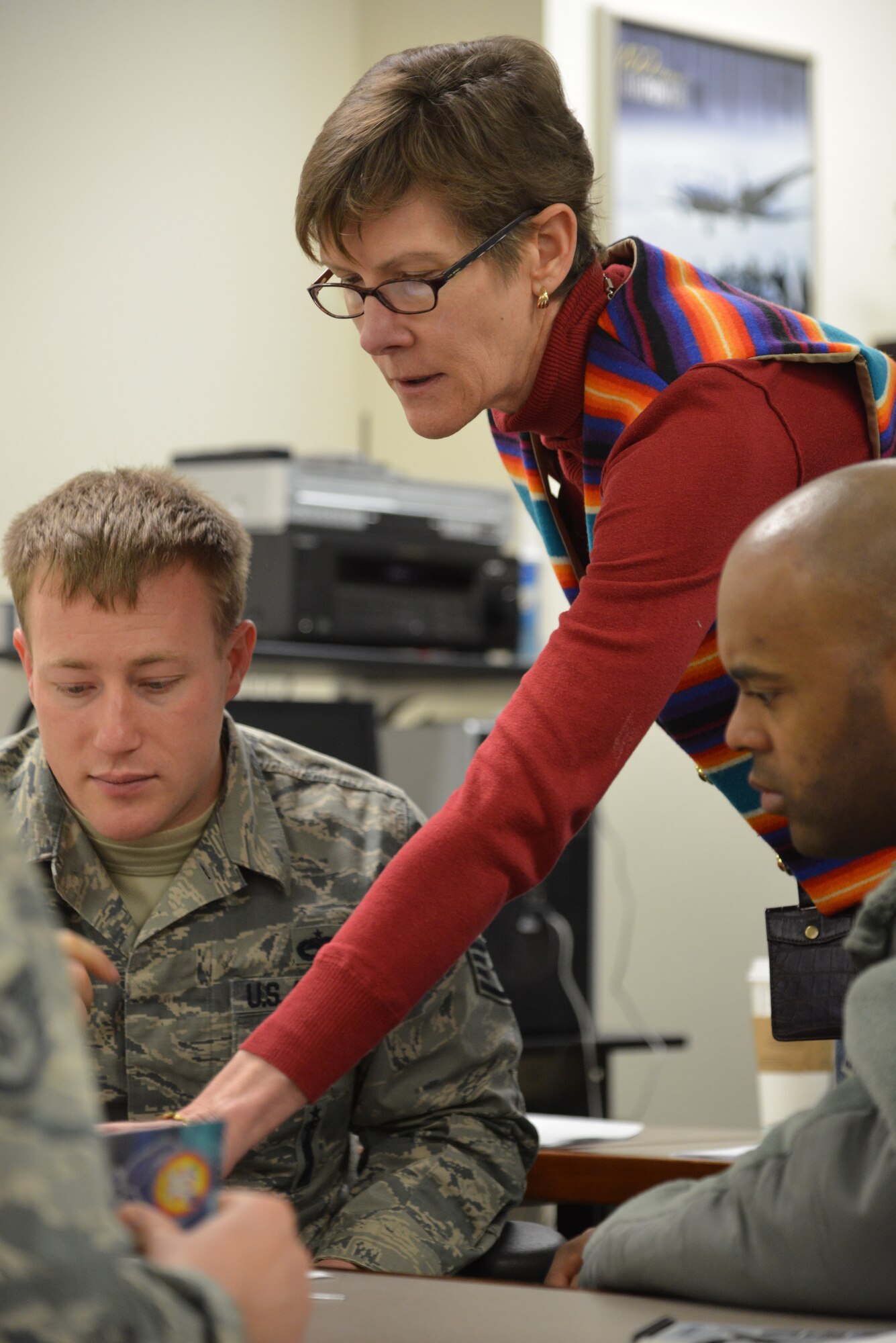 Teresa Reinhard, Kirtland's community support coordinator, helps Airmen while teaching a professional education course on resiliency Jan. 22.  Reinhard was selected as an employee of the quarter by the New Mexico Federal Executive Board.  The honor was given in part for her work in assisting the Wounded, Ill and Injured, as well as promoting resiliency among Team Kirtland members. (Photo by Ken Moore)