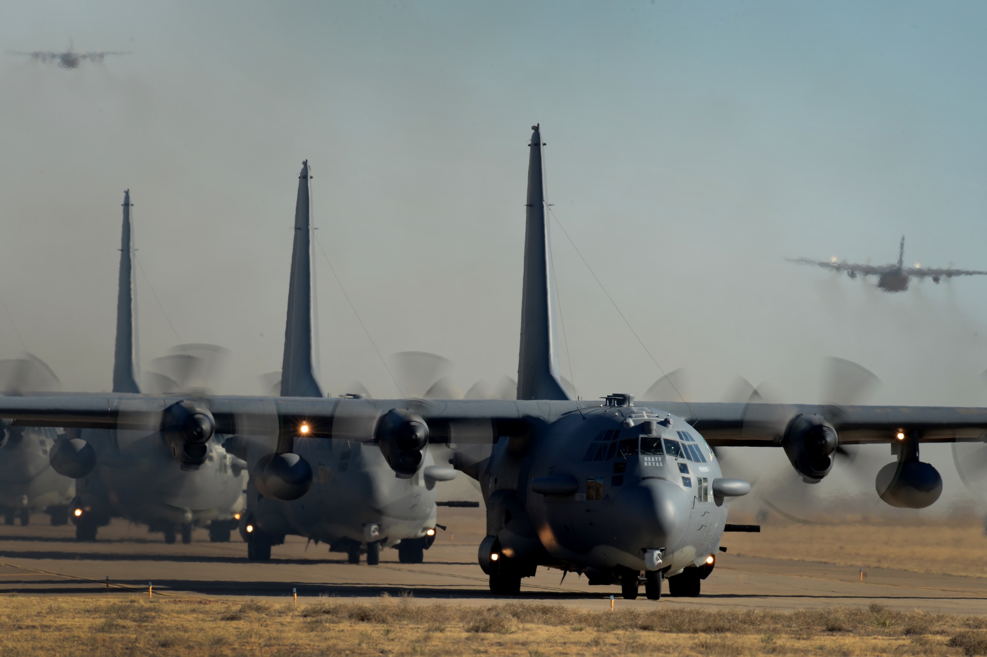 Eight AC-130H Spectre gunships taxi into position on the flightline prior to the final AC-130H mission conducted at Cannon Air Force Base, N.M., Jan. 16. The C-130 began its operational service with the Air Force in 1956 and AC-130 development began in the early 1960s.(U.S. Air Force photo/Staff Sgt. Matthew Plew)