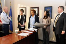 Col. Lester A. Weilacher, 66th Air Base Group commander, speaks to (left to right) Linda Ambard, Andrea McKie, Jersouk Myers and Tom Fredericks before signing a proclamation declaring January as National Slavery and Human Trafficking Prevention Month in the Brown Building Jan. 23. Human Trafficking is a violation of U.S. law and goes against Defense Department core values. (U.S. Air Force photo by Linda LaBonte Britt)