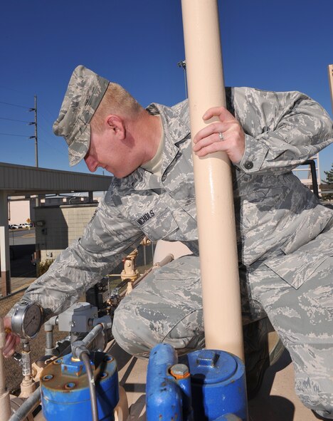 Staff Sgt. Garret Nichols, 78th Logistics Readiness Squadron fuels administration noncommissioned officer in charge, monitors pressure on system piping of a fuel tank during a routine inspection. (U.S. Air Force photo by Tommie Horton)