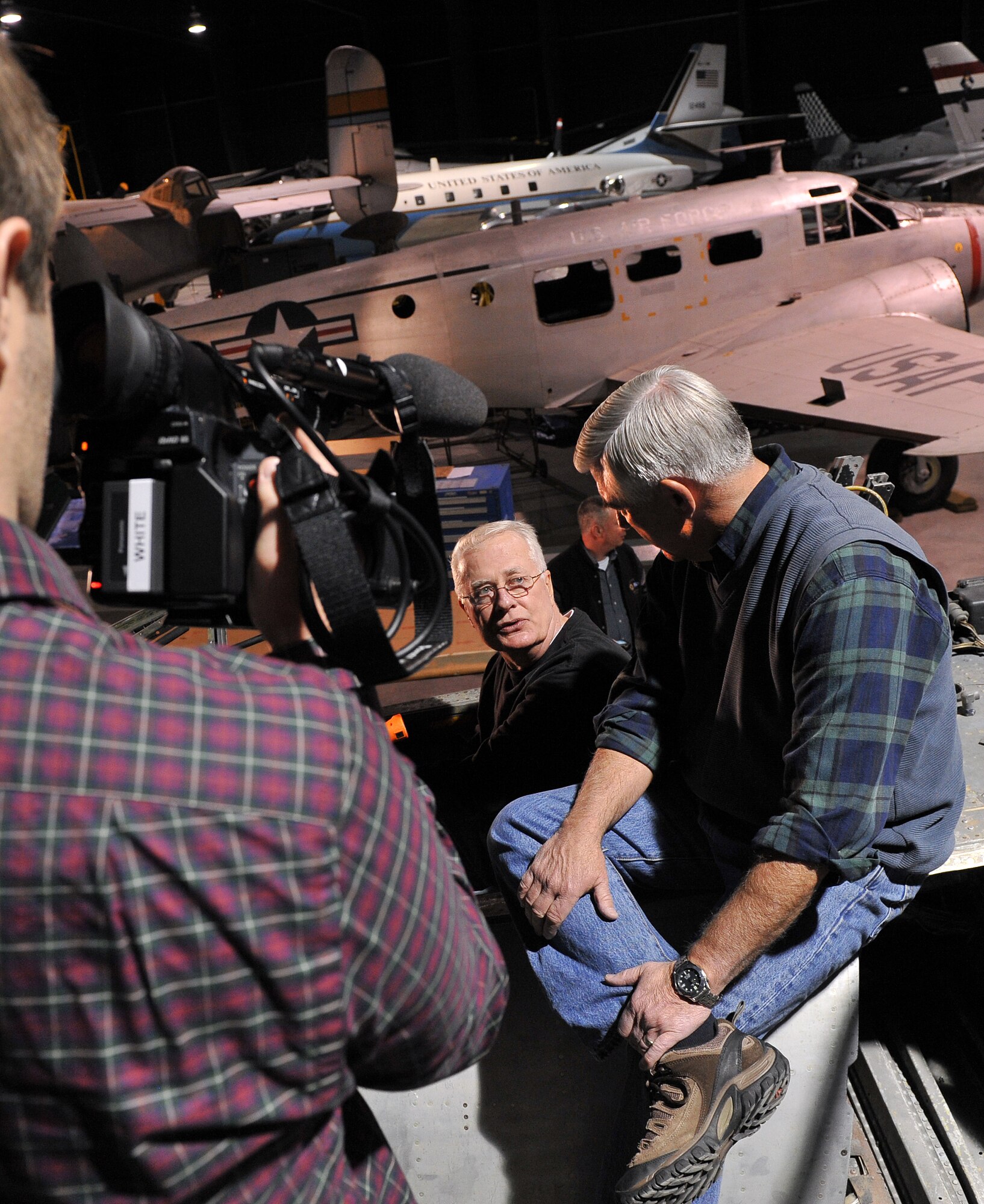 A C-SPAN videographer records as Larry Hubbard, former Air Force crew chief, left, and retired Maj. Gen. Richard Goddard, former Warner Robins Air Logistics Center commander, sit atop an F-100 aircraft currently undergoing restoration at the Robins Museum of Aviation. Both men share a history with the aircraft that was flown by Goddard, above, and serviced by Hubbard during the Vietnam War. (U.S. Air Force photo by Tommie Horton)
