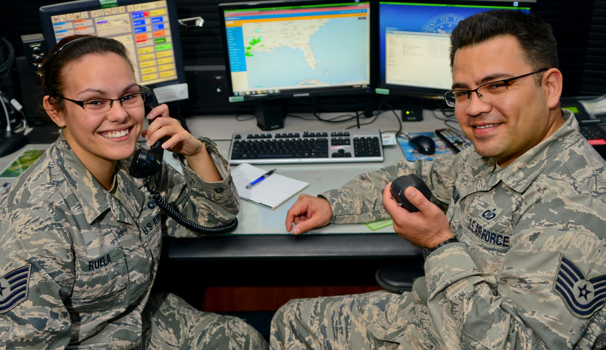 Tech. Sgt. Sandi Ruela, 927th Air Refueling Wing command post training NCO in charge, and Tech. Sgt. Alberto Montellano, 6th Air Mobility Wing command post training NCO in charge, pose for a photo at MacDill Air Force Base, Fla., Jan. 23, 2014. Ruela, Air Force Reservist, and Montellano, active-duty Air Force, work together to ensure that command post Airmen from both the 6th and the 927th are properly trained as one integrated total force. (U.S. Air Force photo by Airman 1st Class Ned T. Johnston/Released)