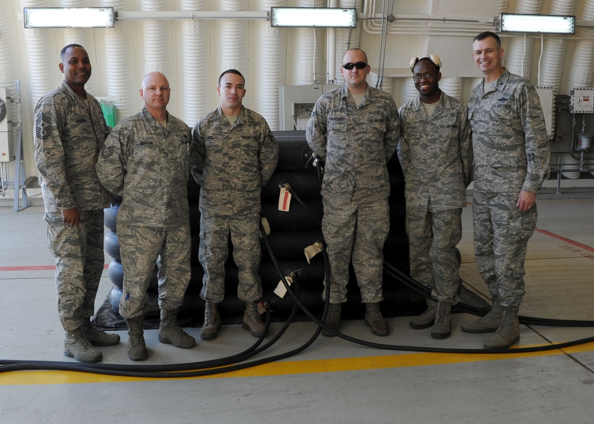 Members from the 39th Maintenance Squadron, Crash Disabled Damaged Aircraft Recovery team, poses for a group photo with Col. Craig Wills, 39th Air Base Wing commander, and Chief Master Sgt. Anthony Johnson, 39th ABW command chief, Jan. 23, 2014, at Incirlik Air Base, Turkey.  The team demonstrated of the squadrons Crash Disabled Damaged Aircraft Recovery capability using the pneumatic airbag system. The air-bag technique is a last resort process, which provides lift capabilities in the event of a damaged aircraft. The CDDAR team maintains the training and knowledge to safely lift a damaged airframe. (U.S. Air Force photo by Staff Sgt. Veronica Pierce/Released)