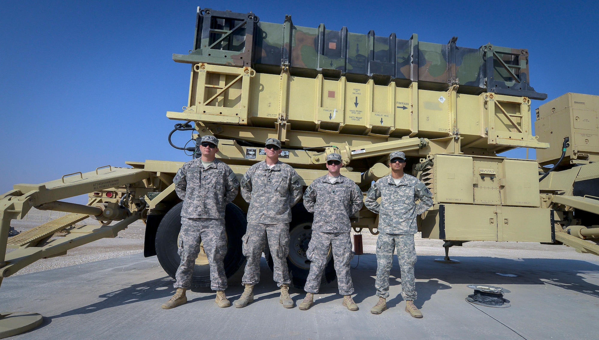 Soldiers from the 3-43 Air Defense Artillery Battalion who are deployed from Fort Bliss, Ga. pose for a group photo in front of a Patriot Missile Weapon System at Al Udeid Air Base, Qatar, Jan. 22, 2013. The Patriot is the Army’s primary surface-to-air missile system and also functions as an anti-ballistic missile system, which protects the base from air and missile attacks. The Patriot is the only anti-ballistic missile system to have successfully engaged and destroyed a tactical ballistic missile in combat. (U.S Air Force photo/Senior Airman Jared Trimarchi)  