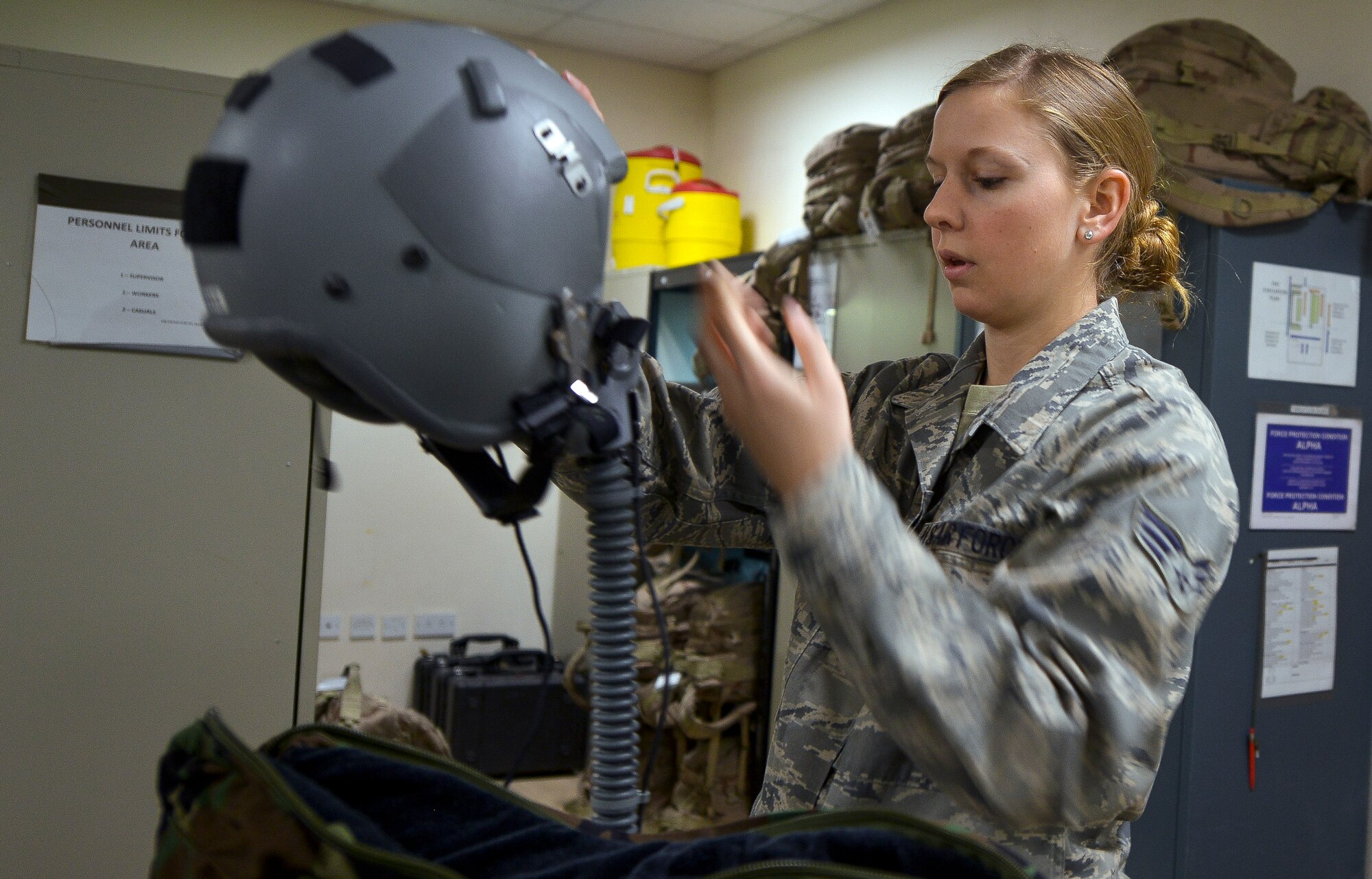 Senior Airman Joy Neuenschwander inspects a flight helmet at Al Udeid Air Base Qatar, Jan. 23, 2014. Neuenschwander is part of the six Airmen who work in the C-130J Aircrew Flight Equipment shop who are deployed from Niagara Falls Air Reserve Station, N.Y. The AFE Airmen inspect, maintain and provide equipment for three to four C-130 aircrews on a daily basis. Neuenschwander is a C-130J AFE technician and a Lancaster, Pa. native. (U.S. Air Force photo/Senior Airman Jared Trimarchi)  
