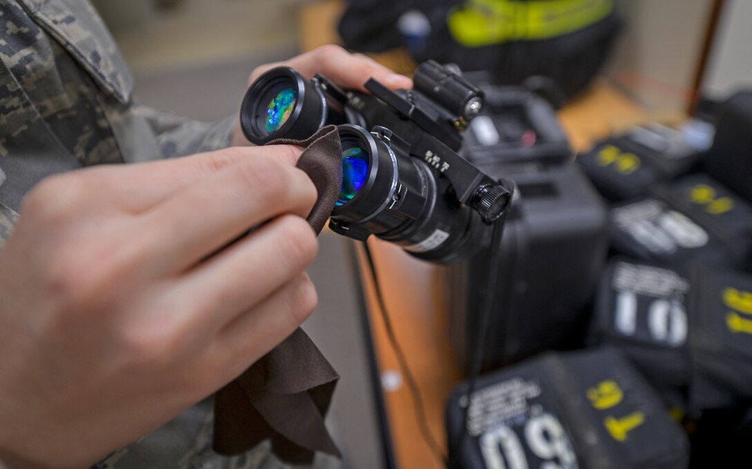 Senior Airman Joy Neuenschwander cleans a pair of night vision goggles at Al Udeid Air Base Qatar, Jan. 23, 2014. Neuenschwander is part of the six Airmen who work in the C-130J Aircrew Flight Equipment shop who are deployed from Niagara Falls Air Reserve Station, N.Y. The AFE Airmen inspect, maintain and provide equipment for three to four C-130 aircrews on a daily basis. Neuenschwander is a C-130J AFE technician and a Lancaster, Pa. native. (U.S. Air Force photo/Senior Airman Jared Trimarchi)  