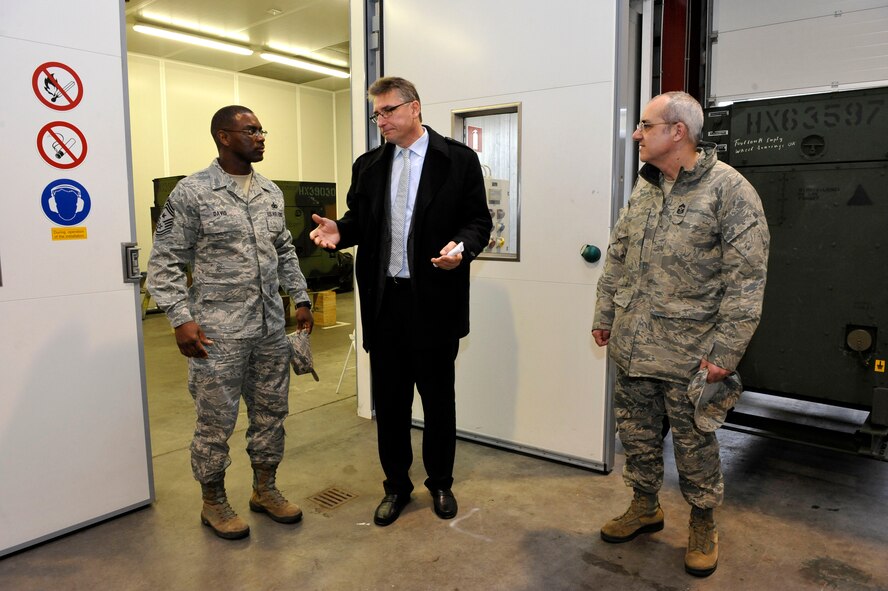 Chief Master Sgt. James Davis (left), U.S. Air Forces in Europe and U.S. Air Forces Africa command chief, and Chief Master Sgt. James Morris (right), 86th Airlift Wing command chief, receive a mission brief and tour from Andres Strans, Central Regional Storage Facility site director at the CRSF site, Jan. 14, 2014, Sanem, Luxembourg. Strans explains the duties and responsibilities of maintenance personnel. (U.S. Air Force photo/Staff Sgt. Leslie Keopka)