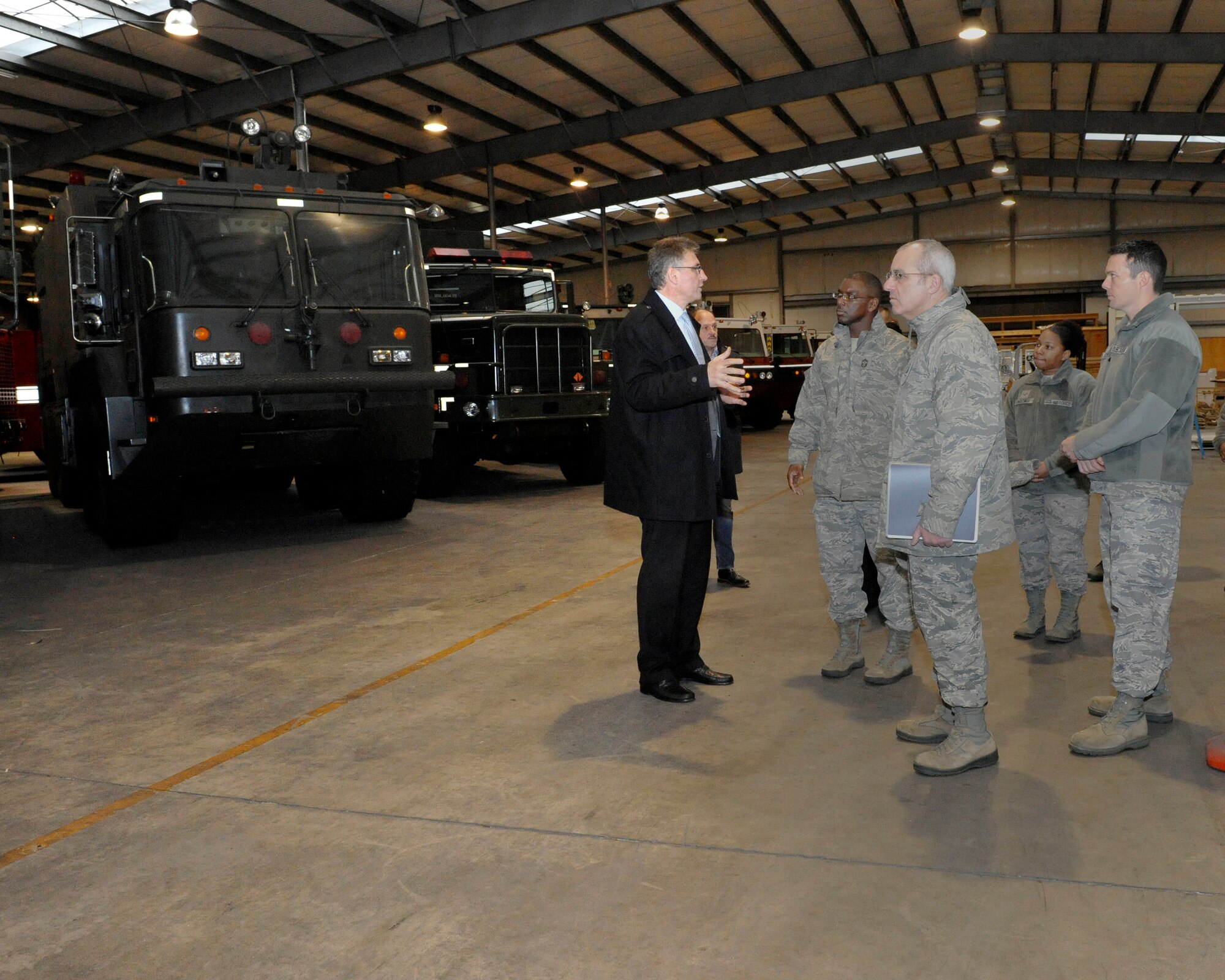 Andres Strans, Central Regional Storage Facility site director, explains to Chief Master Sgt. James Davis, U.S. Air Forces in Europe and U.S. Air Forces Africa command chief and Chief Master Sgt. James Morris, 86th Airlift Wing command chief, how many vehicles are stored at the CRSF at any given time during the immersion tour, Jan. 14, 2014, Sanem, Luxembourg. The CRSF site is currently storing more than $500 million worth of DOD equipment and vehicles. (U.S. Air Force photo/Staff Sgt. Leslie Keopka)