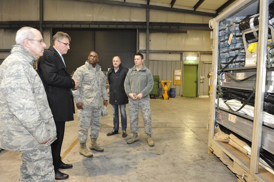 Maj. Ryan Anderson (right), 86th Airlift Wing Material Maintenance Squadron commander, shows Chief Master Sgt. James Morris, 86th Airlift Wing command chief, and Chief Master Sgt .James Davis, U.S. Air Forces in Europe and U.S. Air Forces in Africa command chief, a fully functional and ready-to-be-shipped a Basic Equipment Airfield Requirement kit at the CRFS, Jan. 14, 2014, Sanem, Luxembourg. A BEAR kit is comprised of a fully functional kitchen, shower facility, latrine, and fire extinguishers; all the basic components required when setting up living quarters on an airfield. (U.S. Air Force photo/Staff Sgt. Leslie Keopka)