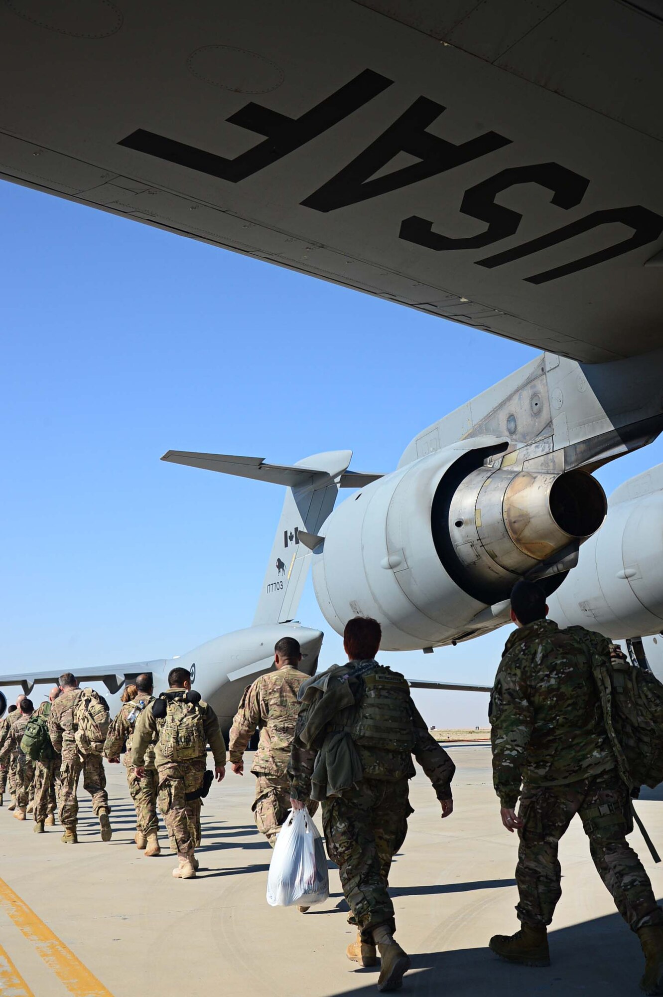 Forward deployer’s board a C-17 Globemaster III destined for Bagram Air Field, Afghanistan, at an undisclosed location in Southwest Asia. Forward deployments are one of the daily operations on the flight line. (U.S. Air Force photo by Senior Airman Desiree W. Moye)