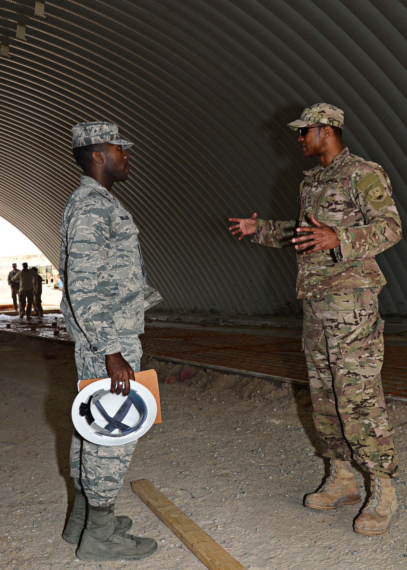2nd Lt. Joshua Bullock, 386th Expeditionary Contracting Squadron infrastructure flight chief, conducts a project site visit to evaluate progress with Senior Master Sgt. Christopher Arceneaux, 1st Expeditionary Civil Engineer Group, 557th Red Horse superintendent, at an undisclosed location in Southwest Asia. The $350,000 structure is replacing older, temporary facilities and will add capability and increase quality of life for the 386th CES Airmen. Bullock is deployed from Holloman Air Force Base, N.M. and a native of Shreveport, La. (U.S. Air Force photo by Senior Airman Desiree W. Moye)