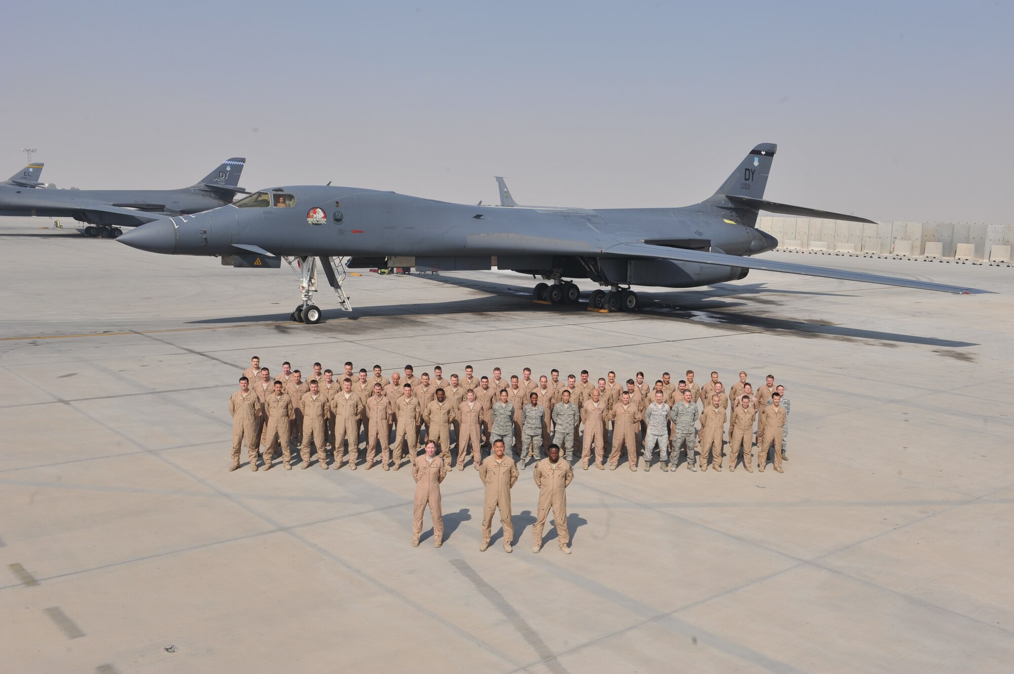Members of the 9th Expeditionary Bomb Squadron pose for a group photo at Al Udeid Air Base, Qatar, Jan. 22, 2014. The 9th EBS, deployed from Dyess Air Force Base, Texas, flew 2,179 flags during their deployment and raised $9,202.24 that was presented to the 379th Expeditionary Medical Group, Intra-Theater Care Program. The ITCP is charged with decompressing critical Level 1 medical facilities downrange, accepting non-urgent general and orthopedic surgical cases, pre-approved battle wounded care, and a host of other illnesses that require medical intervention. Part of the donation will go to buy supplies to refurbish patient rooms and provide morale events while they are here. (U.S. Air Force photo by Master Sgt. David Miller)