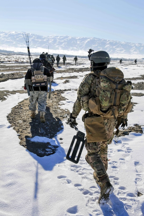 U.S. Special Forces soldiers follow Afghan forces during a clearing operation in Jafare Sufla in the Shah Joy district in Afghanistan's Zabul province, Jan. 15, 2014.