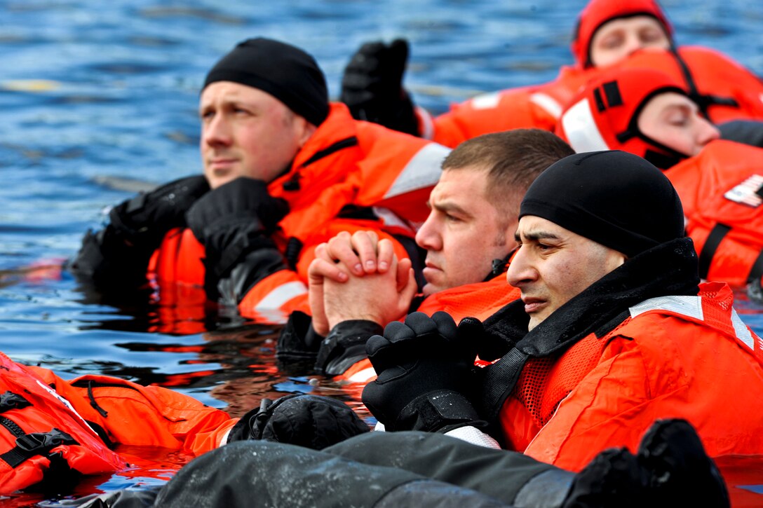 Members of the Coast Guard's Vessel Boarding and Security Team participate in a cold-water survival  exercise in Curtis Creek, Baltimore, Jan. 19, 2014. Service members gain valuable experience and training as they don the appropriate gear to survive cold elements.