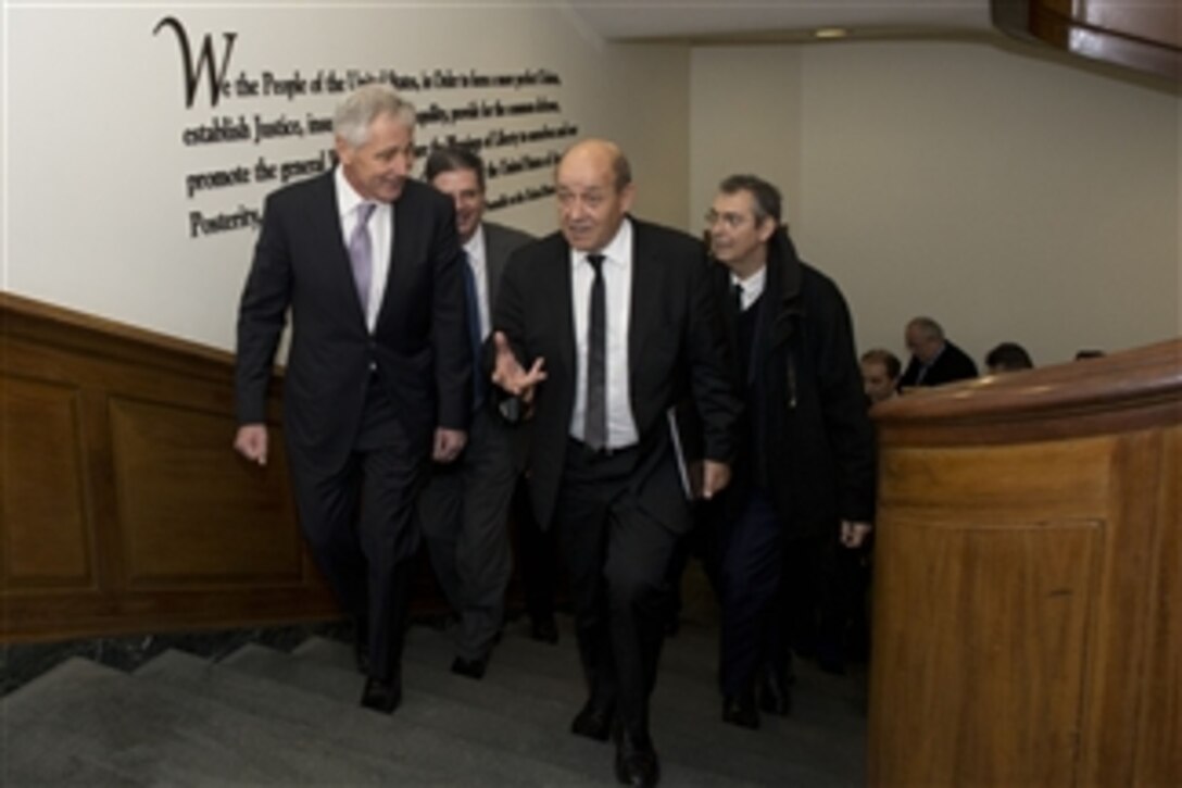 U.S. Defense Secretary Chuck Hagel escorts French Defense Minister Jean-Yves Le Drian to a meeting to discuss defense concerns at the Pentagon, Jan. 24, 2014. Both defense leaders briefed the media in a news conference following the meeting.