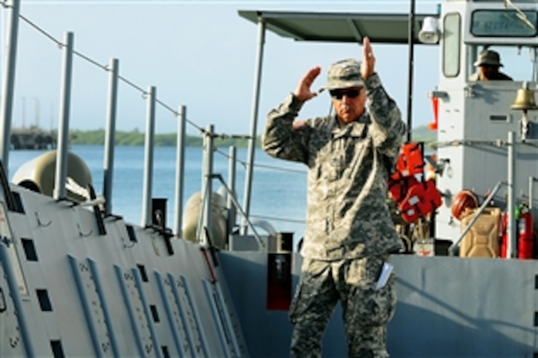 Army Staff Sgt. Jose Melendez gives directions for loading equipment before sailing out to Vieques, Puerto Rico, Jan. 20, 2014. Melendez is assigned to the Puerto Rico Army National Guard's Landing Craft Detachment. 