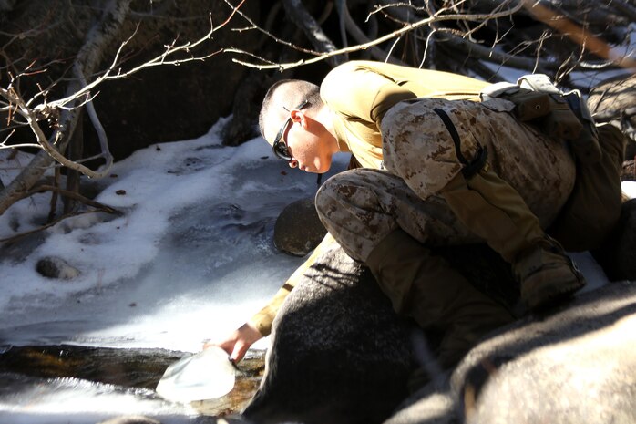 A Marine with 2nd Battalion, 2nd Marine Regiment, 2nd Marine Division, collects water from a mountain stream during a hike at the Marine Corps Mountain Warfare Training Center in Bridgeport, Calif. To gain an expeditionary mindset the Marines and Sailors of 2nd Battalion, 2nd Marines and Ragnarok Co., 2nd Marine Logistics Company, conducted a 10-day field exercise, which consisted of long range day and night foot movement through extremely rugged terrain with drastic elevation changes and tested the Marines’ endurance.