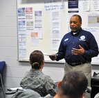 Ernest Farmer, Outreach Specialist with the the Psychological Health Advocacy Program, speaks to Security Forces member about the services his program offers to Airmen and their families. The former Active Duty Airmen, who was deployed three times while in the Mental Health career field in the Air Force, easily related to the oft deployed Security Forces Airmen. (U.S. Air Force Photo by Tech. Sgt. Carlos J. Trevino)
