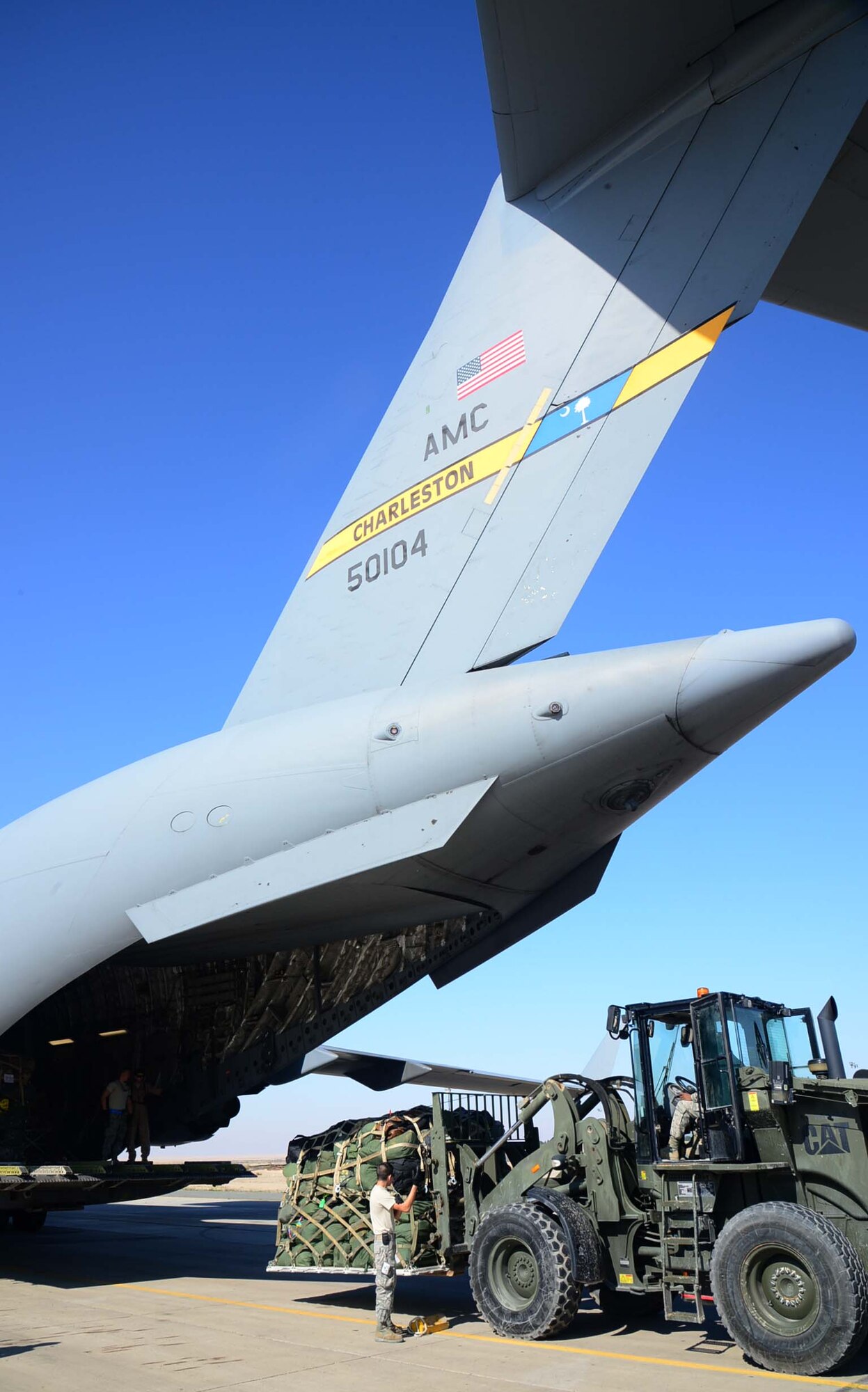 Members from the 386th Expeditionary Logistics Readiness Squadron air transportation operations center prepare a C-17 Globemaster III for a forward deployment to Bagram Air Field, Afghanistan, at an undisclosed location in Southwest Asia. Forward deployments are one of the daily operations on the flight line. (U.S. Air Force photo by Senior Airman Desiree W. Moye)