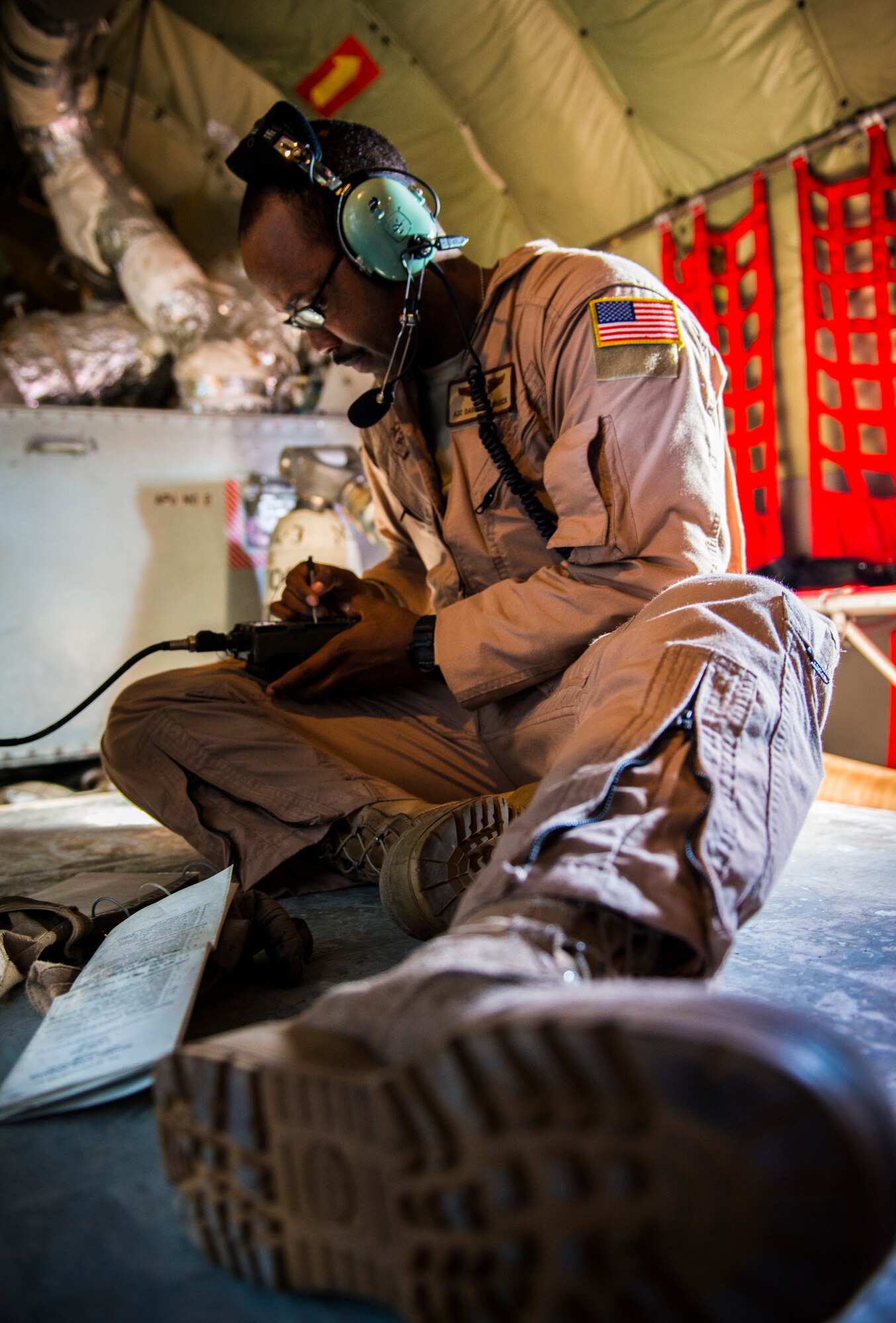 Airman 1st Class Darhon Hambrick, 22nd Expeditionary Air Refueling Squadron in-flight refueling specialist, checks a communication device on board a KC -135 Stratotanker at the Transit Center at Manas, Kyrgyzstan, Jan. 17, 2014. An in-flight refueling specialist, or “boom,” is responsible for safely refueling other aircraft in flight. Hambrick is deployed from MacDill Air Force Base, Fla., and is a native of Nashville, Tenn. (U.S. Air Force photo/Staff Sgt. Travis Edwards)
