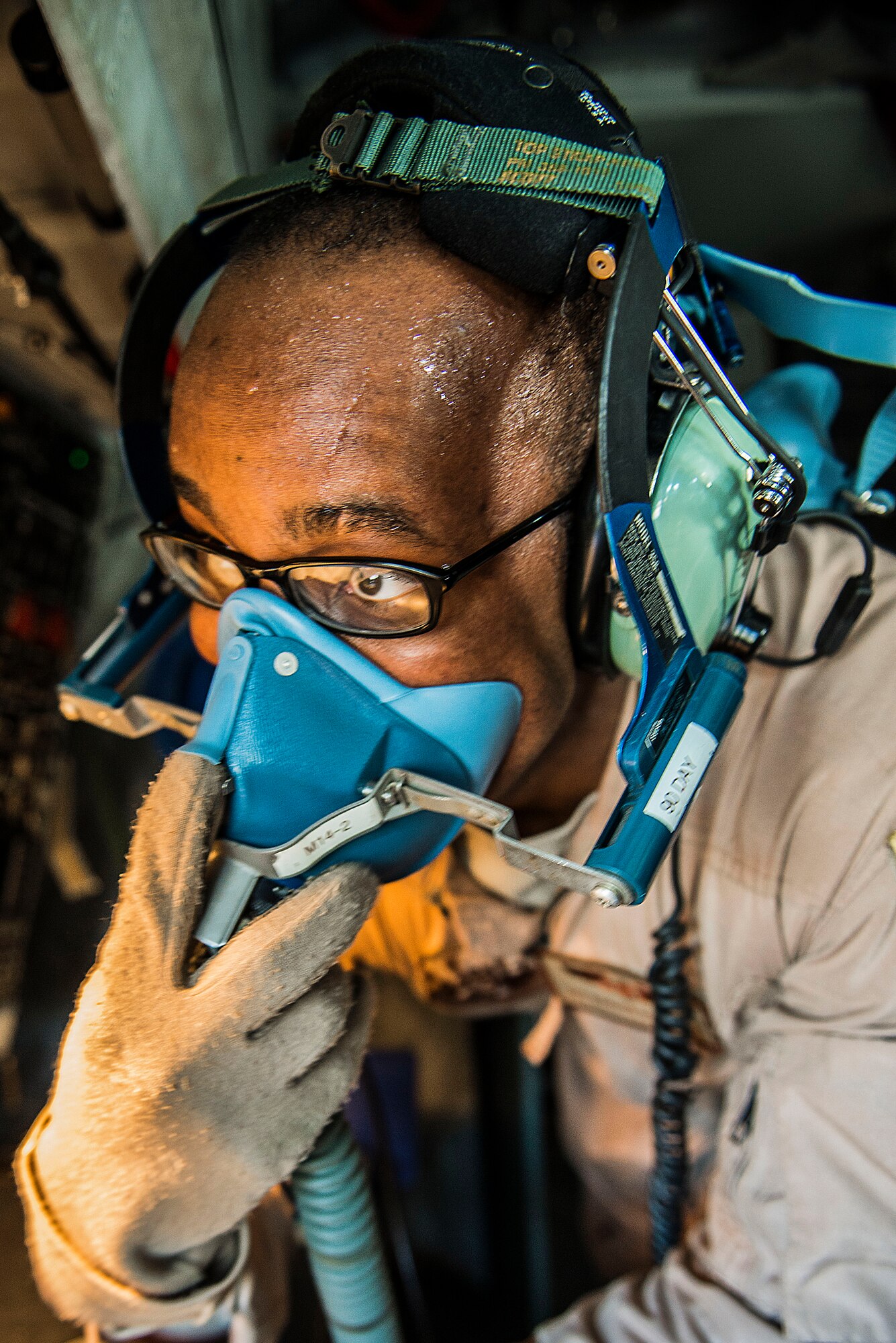 Airman 1st Class Darhon Hambrick, 22nd Expeditionary Air Refueling Squadron in-flight refueling specialist, checks an oxygen mask for proper operation during a pre-flight check of a KC-135 Stratotanker at the Transit Center at Manas, Kyrgyzstan, Jan. 17, 2014. The KC-135 is Air Force aircraft capable of delivering more than 30,000 gallons of fuel to aircraft in flight. Hambrick is deployed from MacDill Air Force Base, Fla., and is a native of Nashville, Tenn. (U.S. Air Force photo/Staff Sgt. Travis Edwards)
