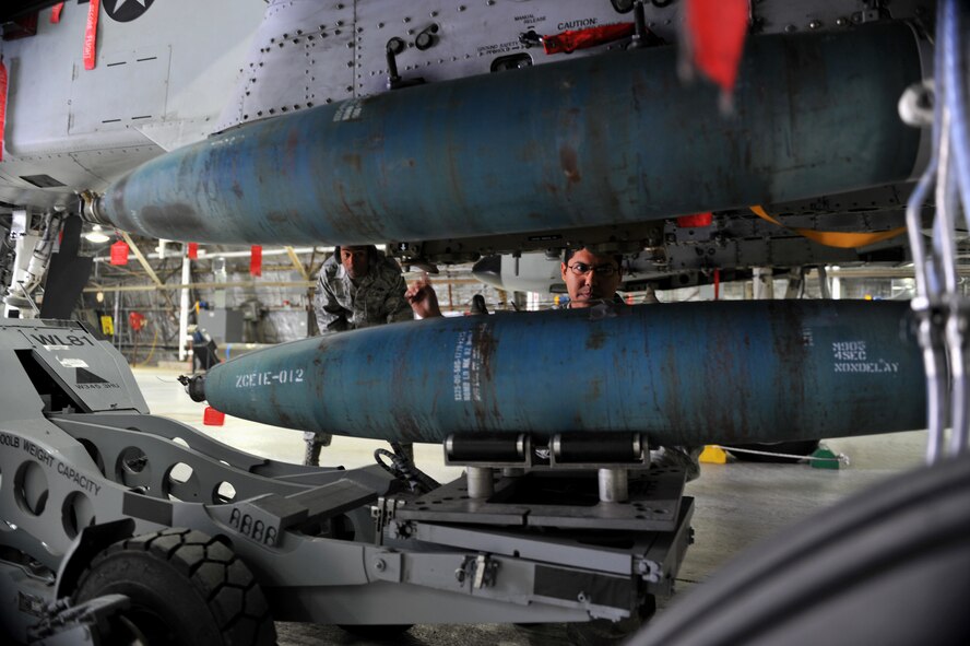 Senior Airman Antonio Chavez, 25th Aircraft Maintenance Unit weapons loader, guides a bomb onto an A-10 Thunderbolt II during a quarterly weapons load crew competition at Osan Air Base, Republic of Korea, Jan. 24, 2014. Load crew competitions are held to give weapons personnel the opportunity to display their war-fighting skills and to unveil the best weapons load crew for a particular quarter during the year. (U.S. Air Force photo/Senior Airman Siuta B. Ika)