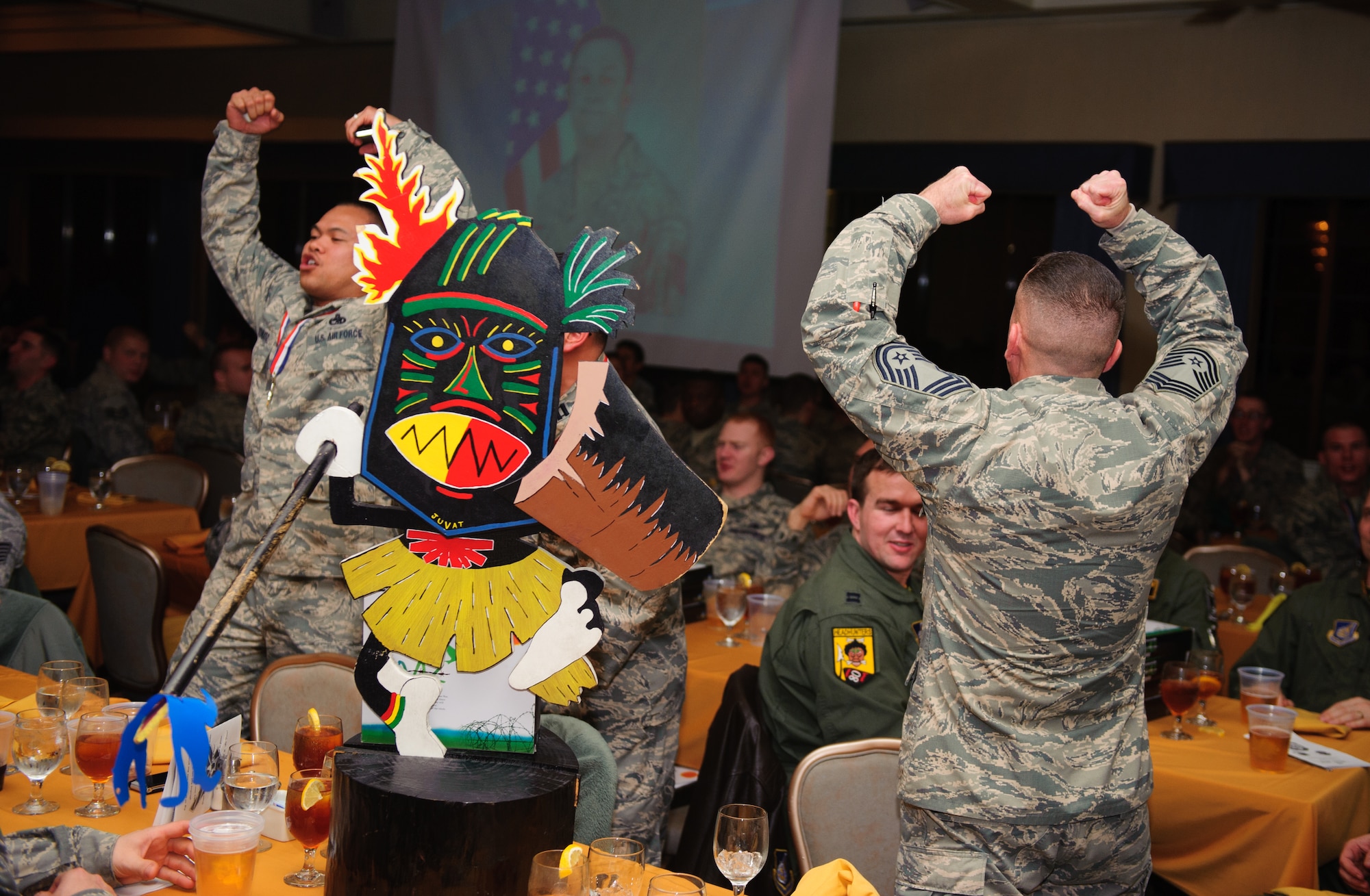 Airmen from the 80th Aircraft Maintenance Unit cheer for their squadrons’ nominees during the Maintenance Professional of the Year banquet at Kunsan Air Base, Republic of Korea, Jan. 23, 2014. The MPOY banquet recognizes the achievements of the maintenance group and honors maintenance professionals each year. (U.S. Air Force photo by Senior Airman Armando A. Schwier-Morales/ Released)