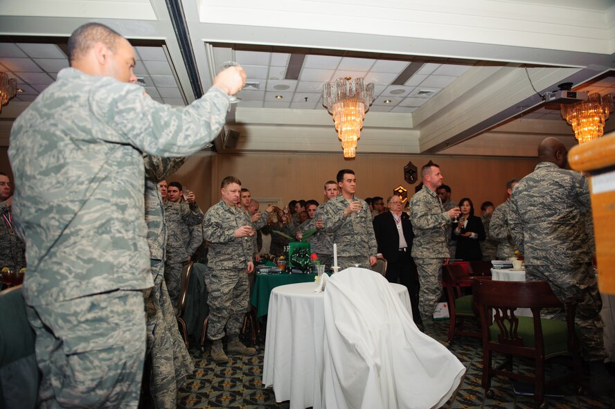Airmen from the 8th Maintenance Group give a silent toast to the prisoner of war and missing in action prior to the Maintenance Professional of the Year banquet at Kunsan Air Base, Republic of Korea, Jan. 23, 2014. The MPOY banquet recognizes the achievements of the maintenance group and honors maintenance professionals each year. (U.S. Air Force photo by Senior Airman Armando A. Schwier-Morales/ Released)