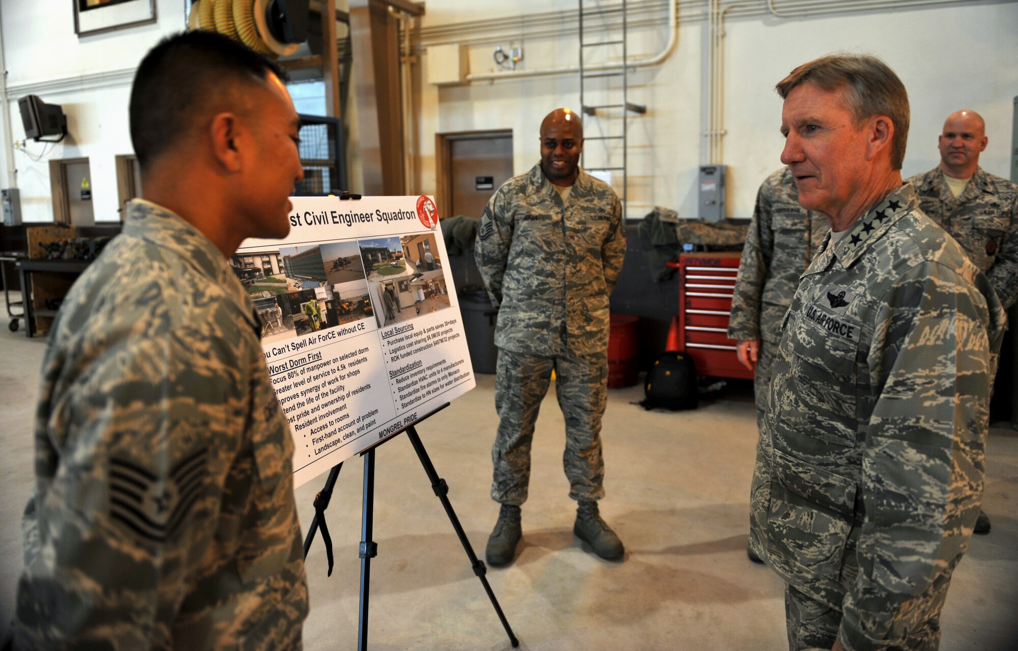 Gen. Hawk Carlisle, Pacific Air Forces commander, speaks to Tech. Sgt. William Deguzman, 51st Civil Engineer Squadron, at Osan Air Base, Republic of Korea, Jan. 23, 2014. Deguzman briefed Carlisle on the cost benefits of the 51st CES’s Worst Dorm First program. (U.S. Air Force photo/Senior Airman Siuta B. Ika)